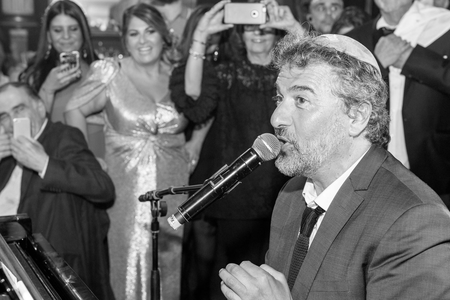 A series of black and white candid photographs showing people laughing and enjoying themselves at what appears to be an event.