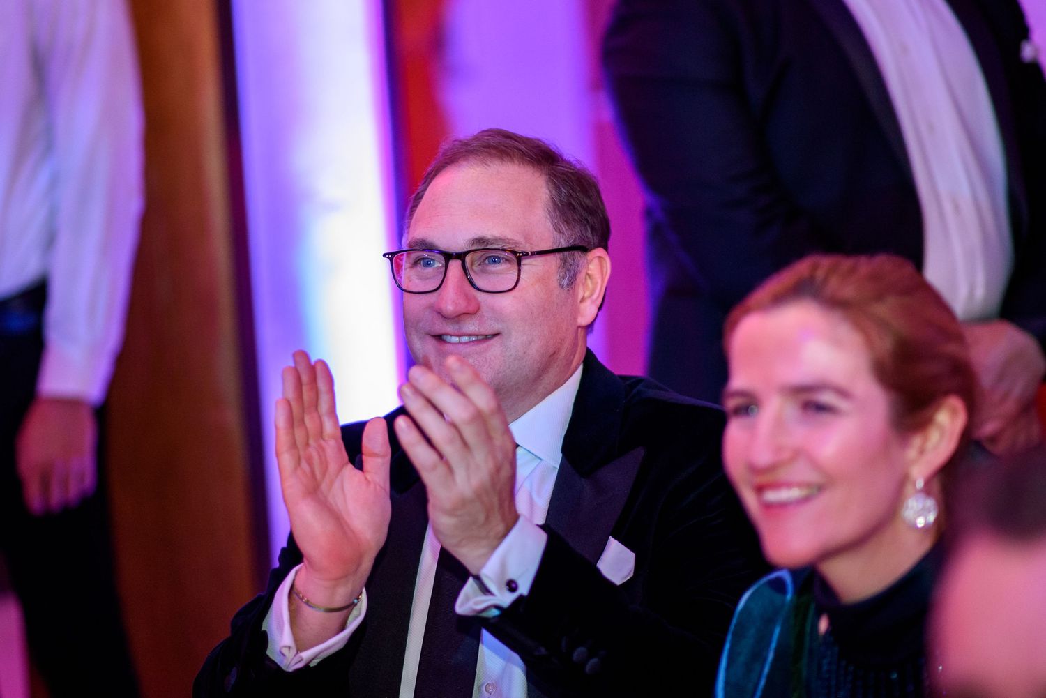 Guests enjoying themselves at an elegantly lit evening celebration.