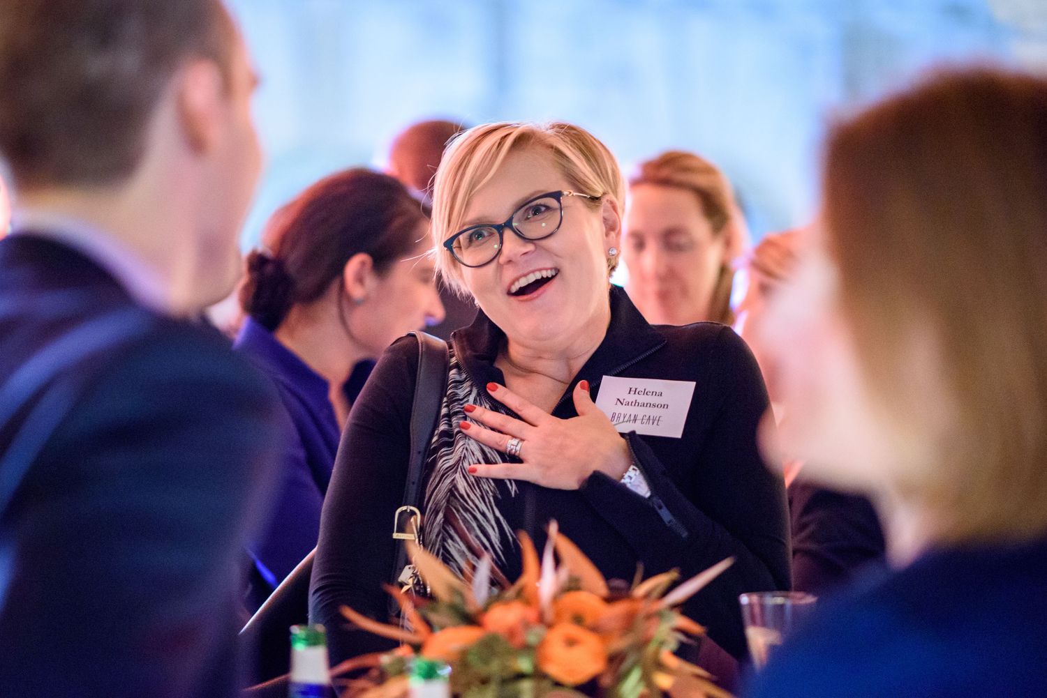 Candid moments captured during an evening social gathering with atmospheric lighting.