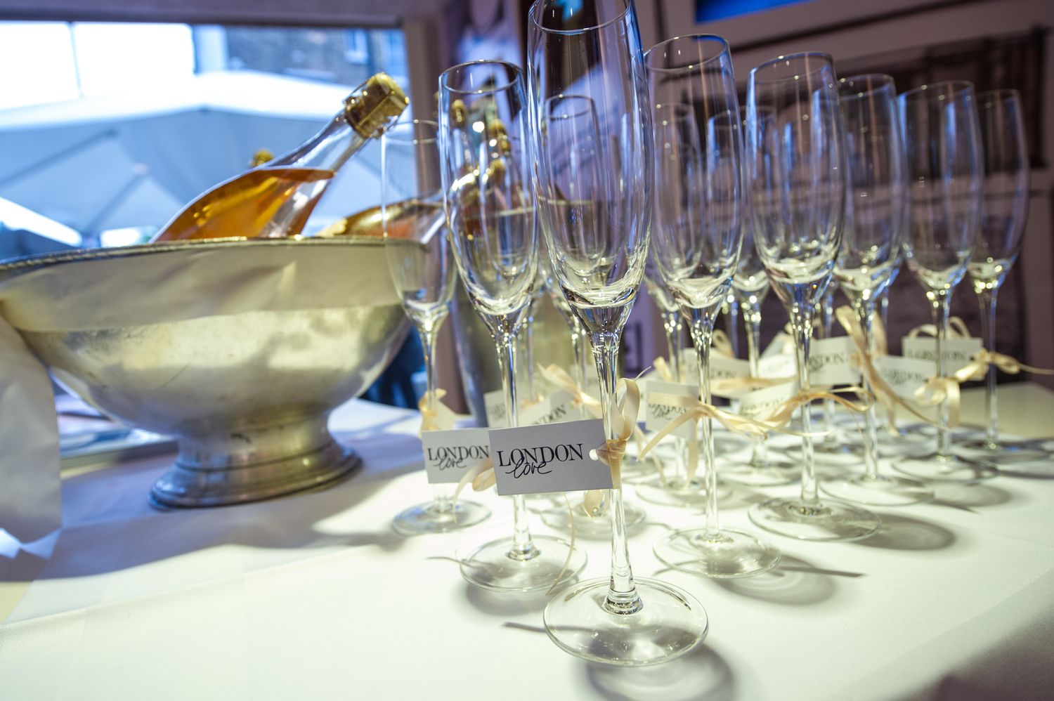 Row of empty wine glasses set up for formal dining service.