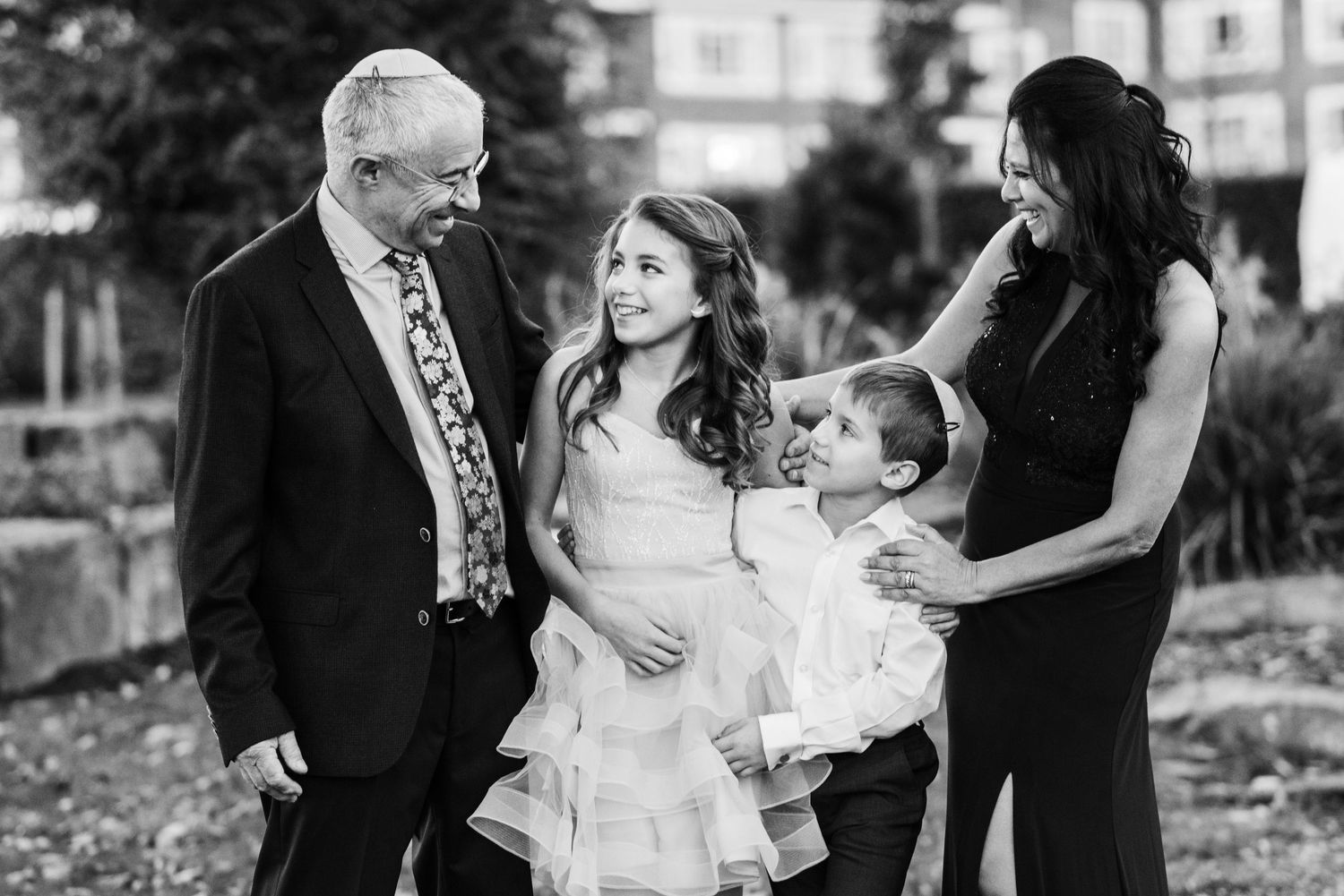 A black and white collage of romantic wedding moments showing couples embracing and celebrating their special day.