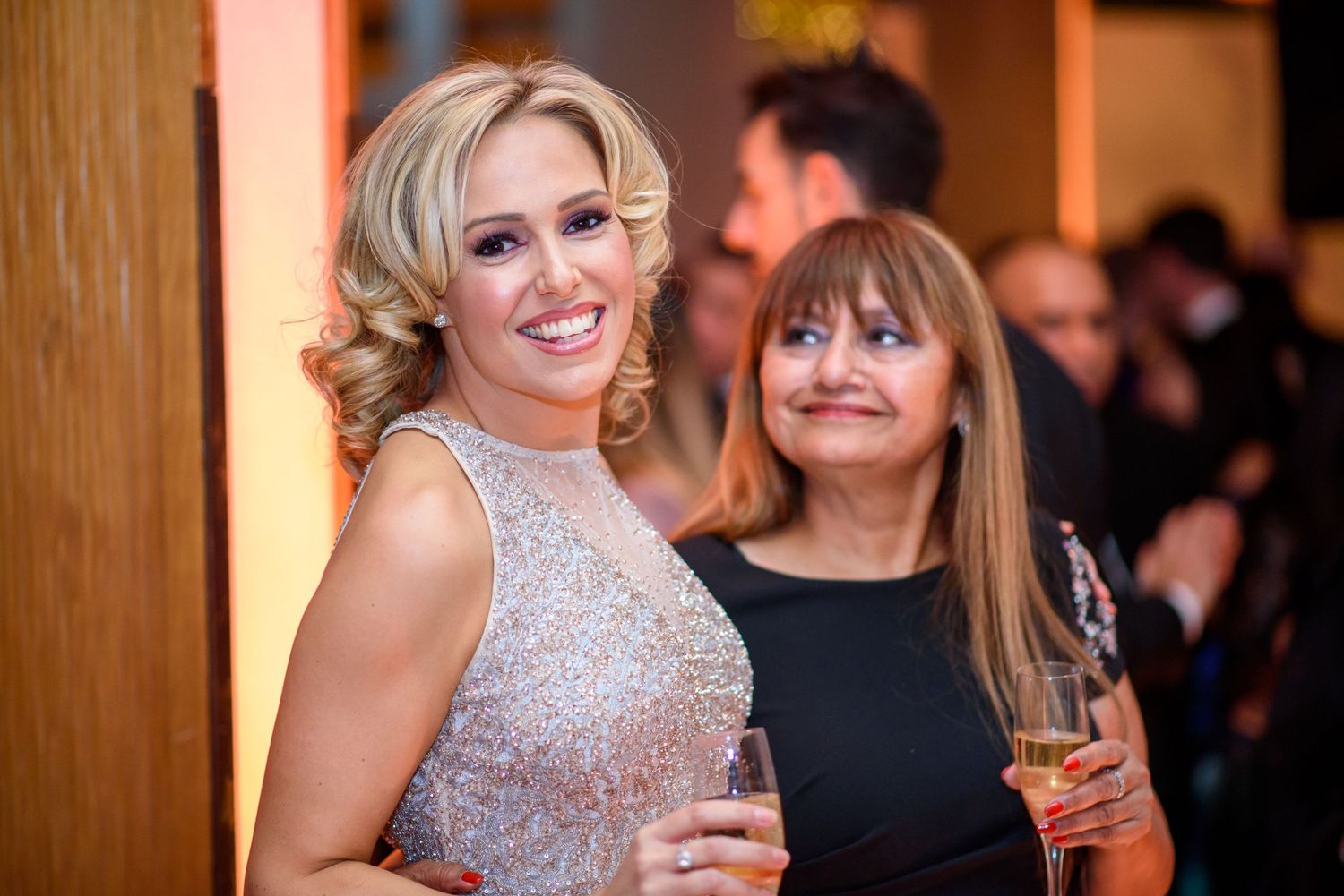 Guests enjoying drinks and conversation at an upscale evening gala.