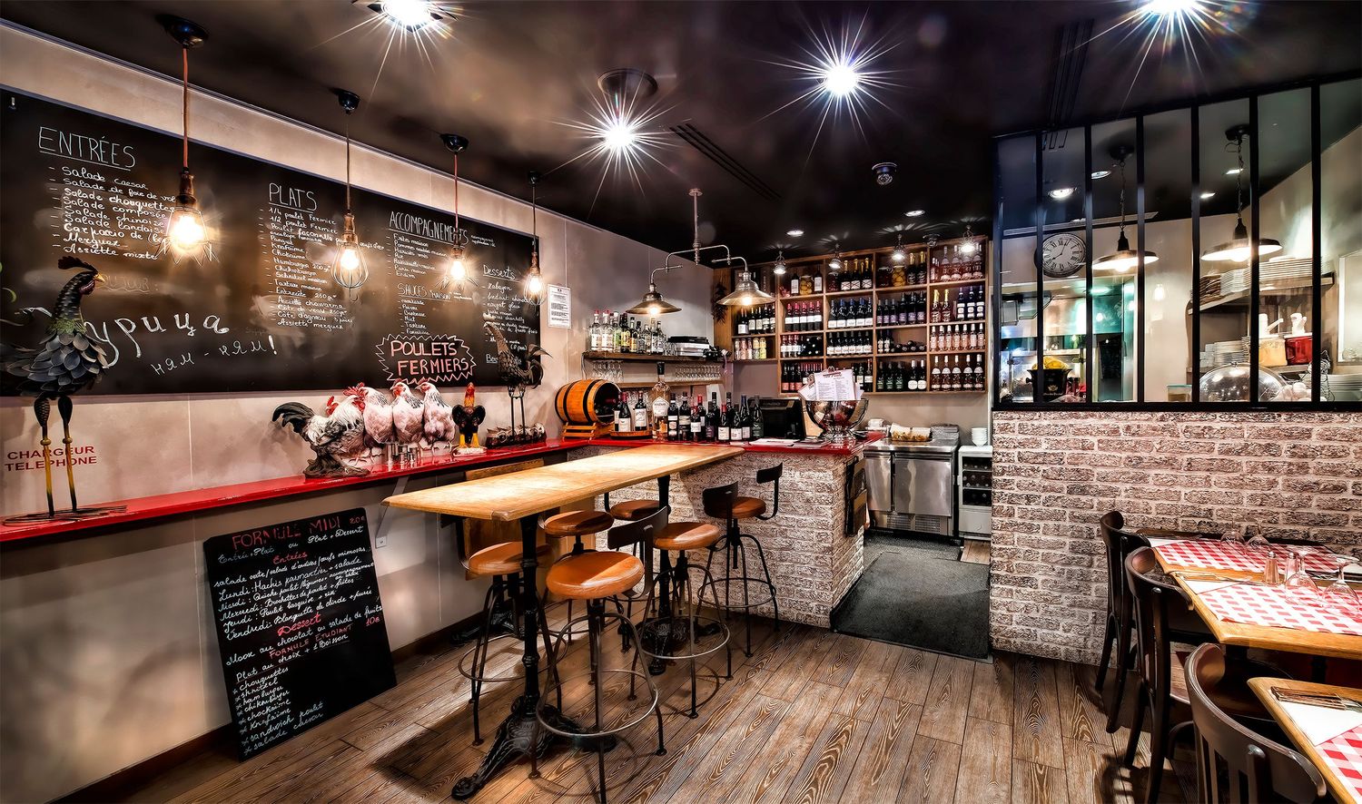 Modern restaurant interior with exposed brick walls, mood lighting and bar seating.