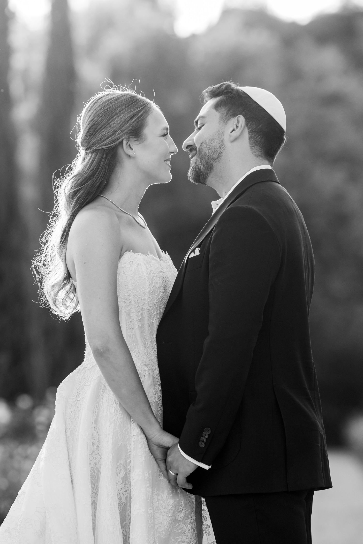 Black and white wedding photos show a bride and groom sharing intimate moments together outdoors.
