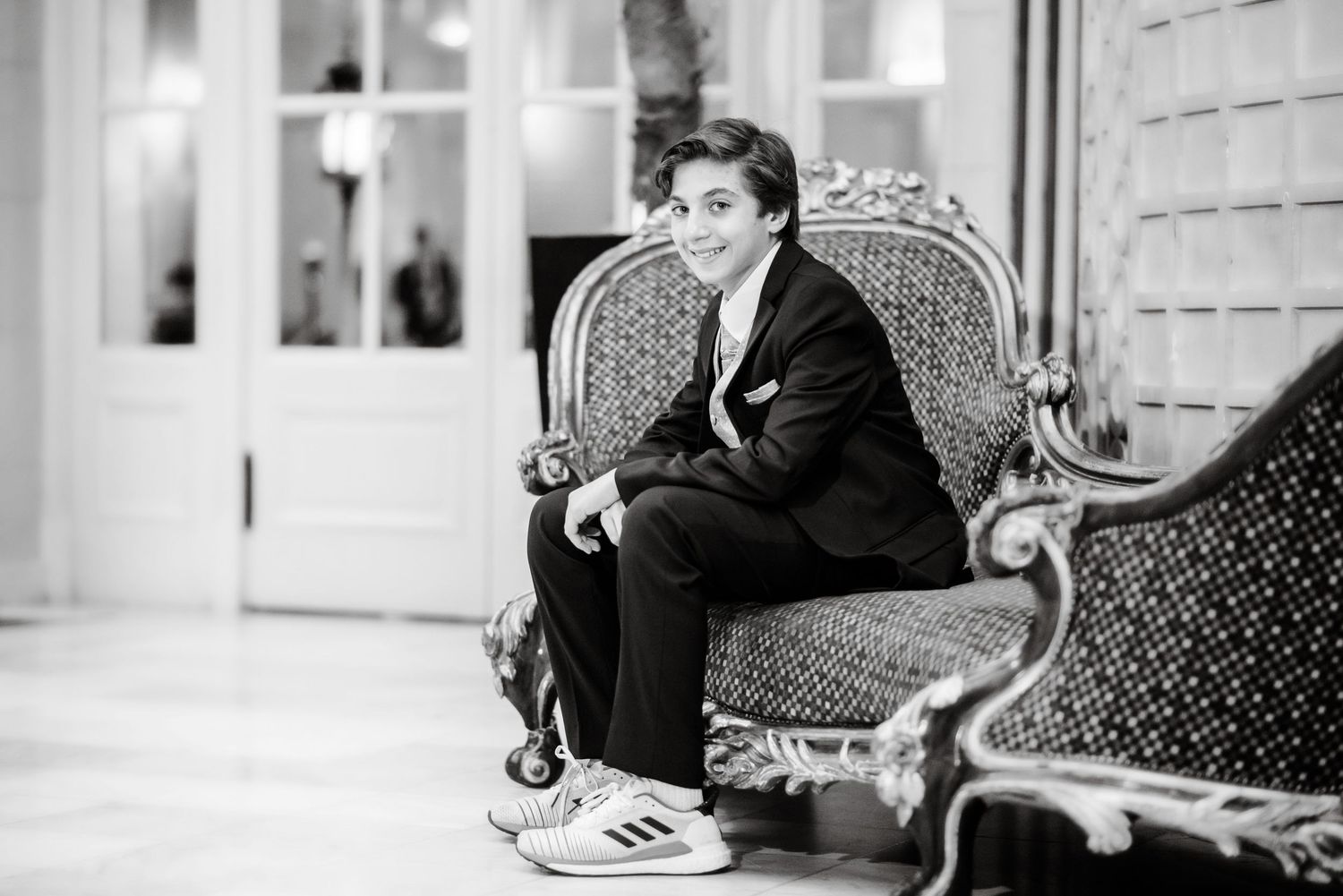 A vintage black and white photo series showing someone lounging and posing on ornate furniture in different positions.