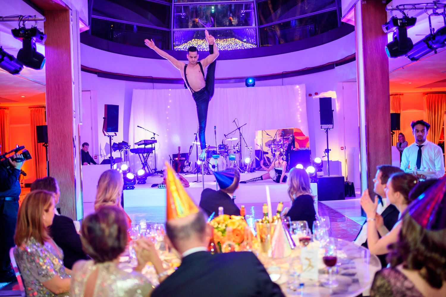Wedding venue with dramatic purple lighting and stage setup for entertainment.