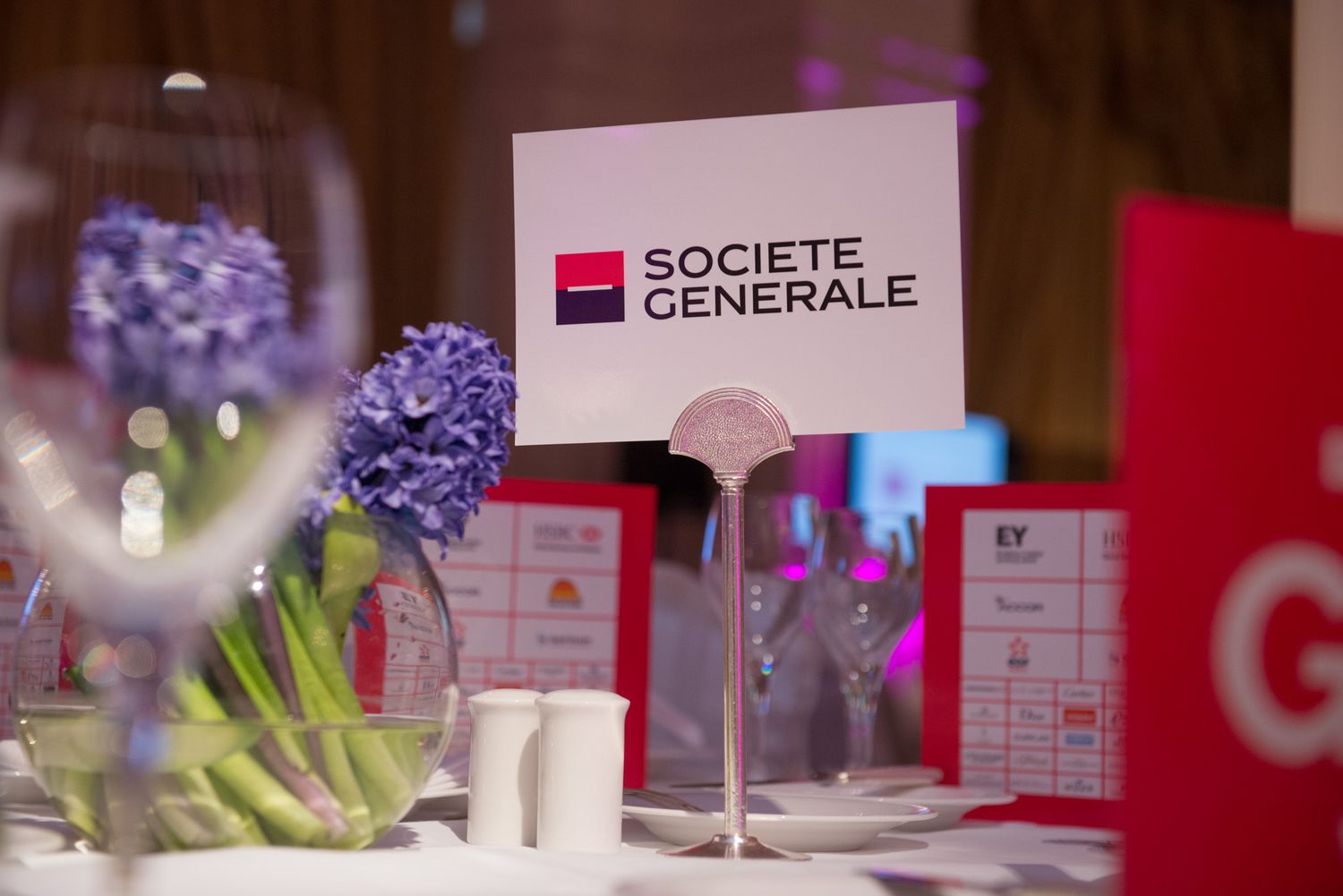 Corporate event setup featuring Societe Generale branding and table settings.