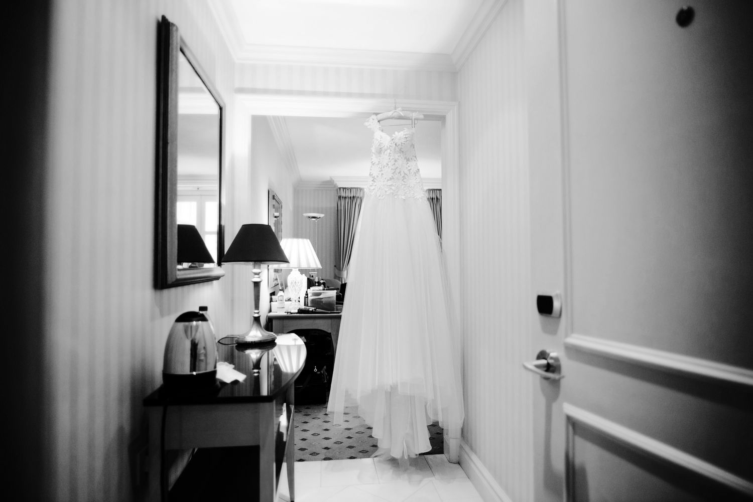 Black and white interior photos showing a minimalist hotel hallway and rooms with modern furnishings and decor.