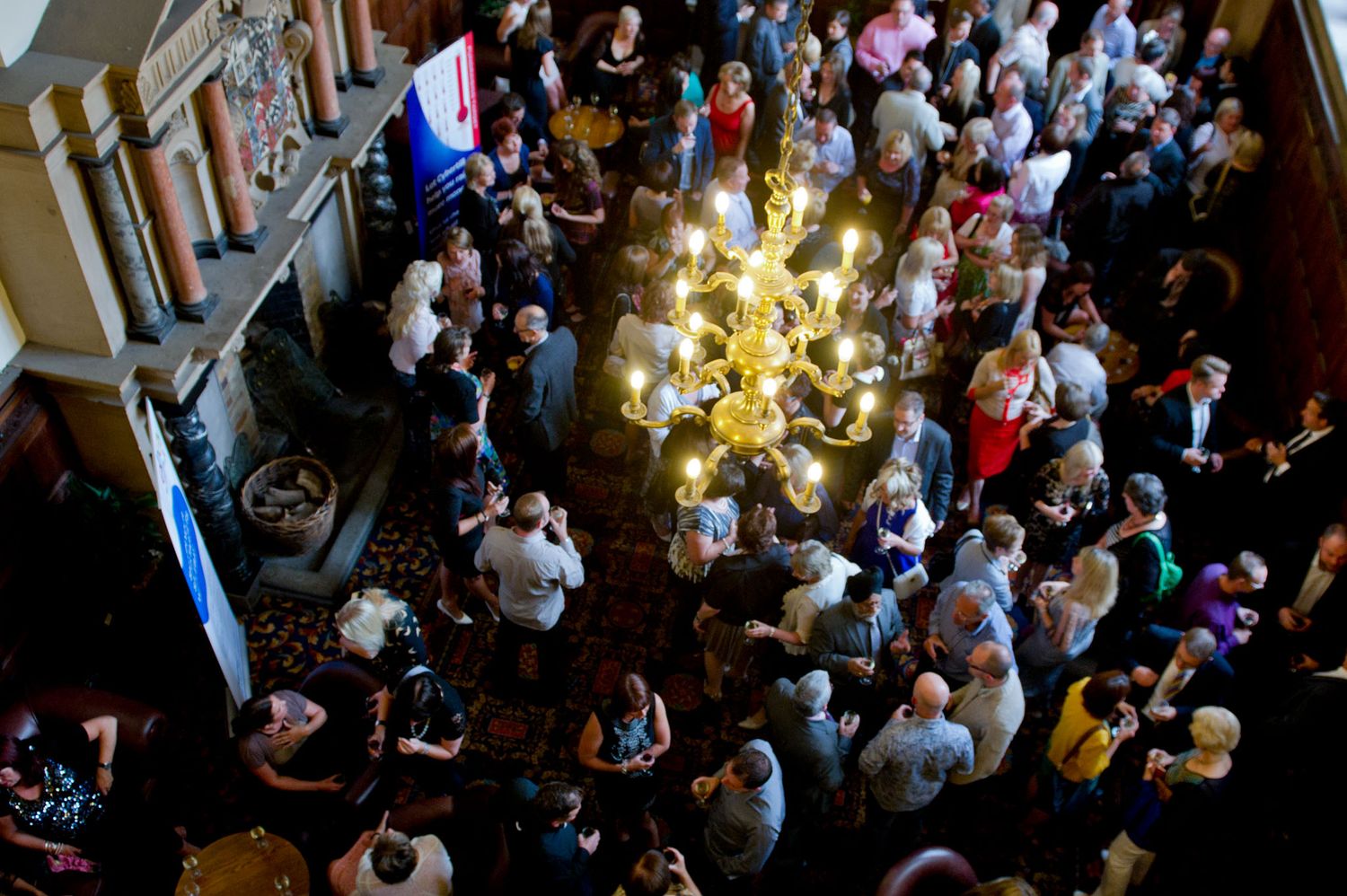 Large crowd gathered in an elegant indoor venue during an event.