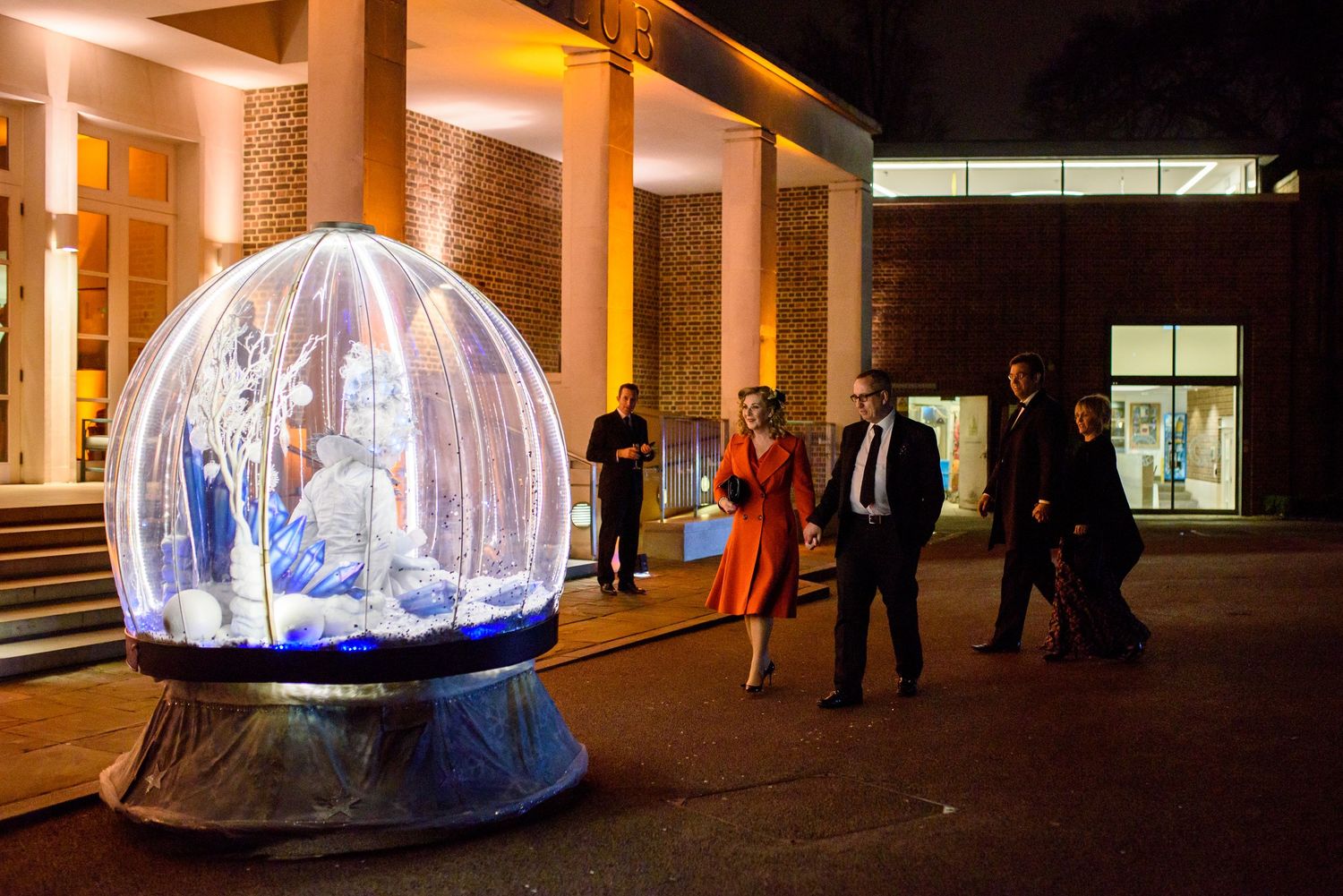 Large illuminated dome structures create ambient lighting in a modern venue space.