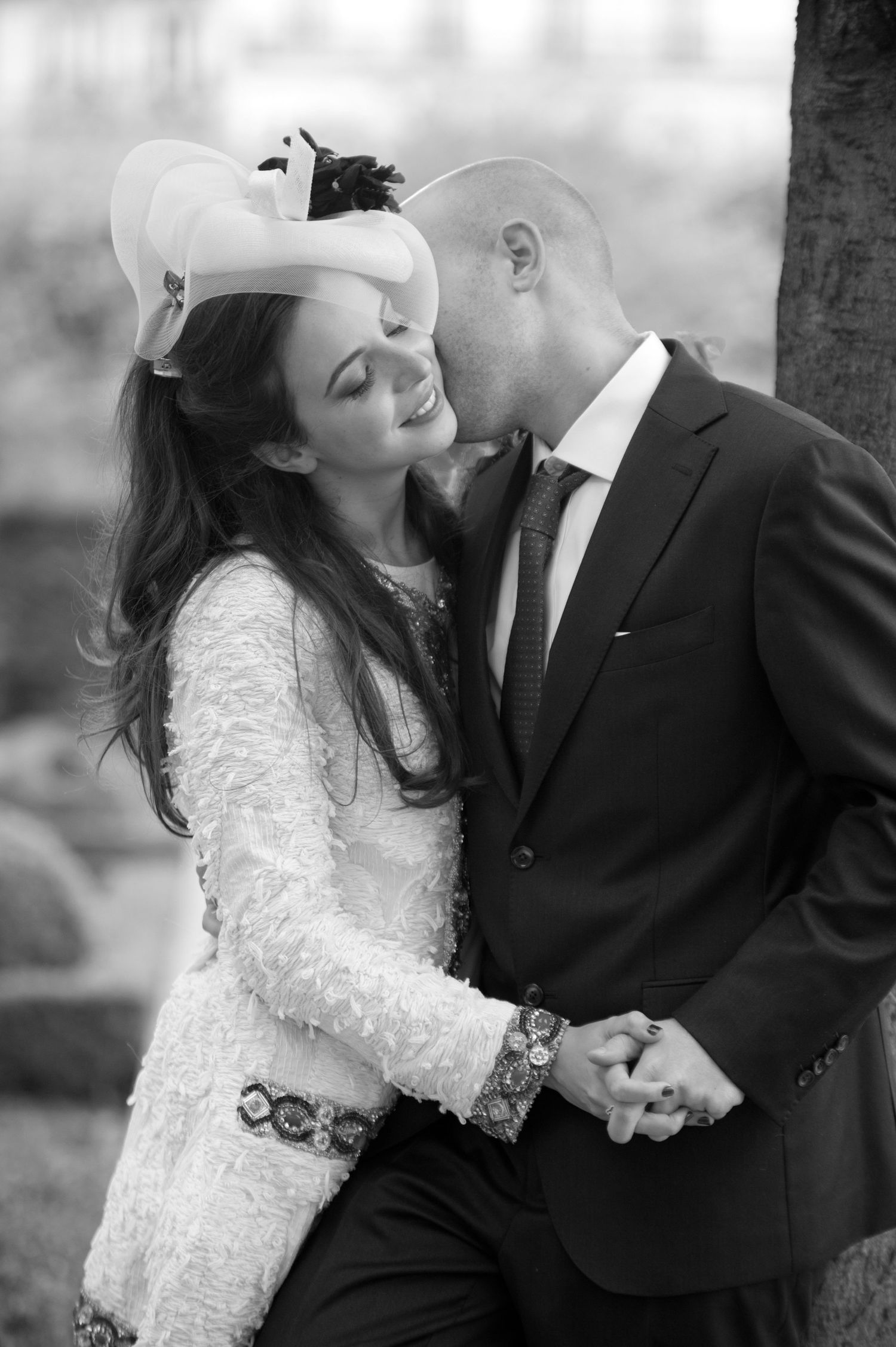 A romantic black and white photo series showing a couple in wedding attire sharing intimate moments together.