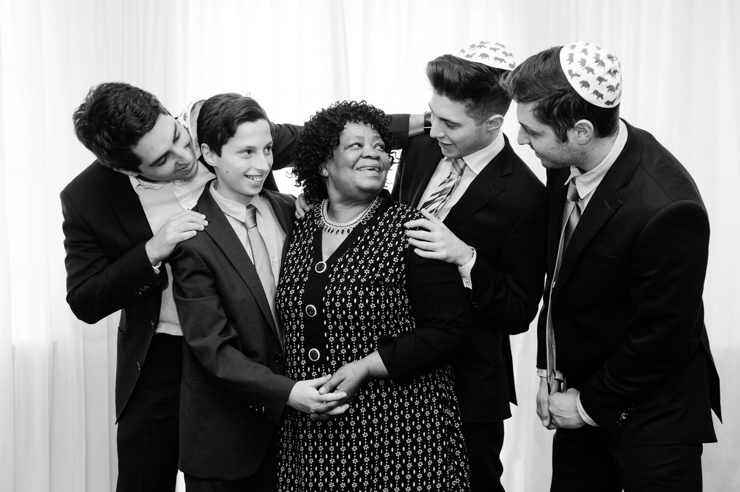 A group of people dancing and socializing at a formal event in black and white vintage photograph.