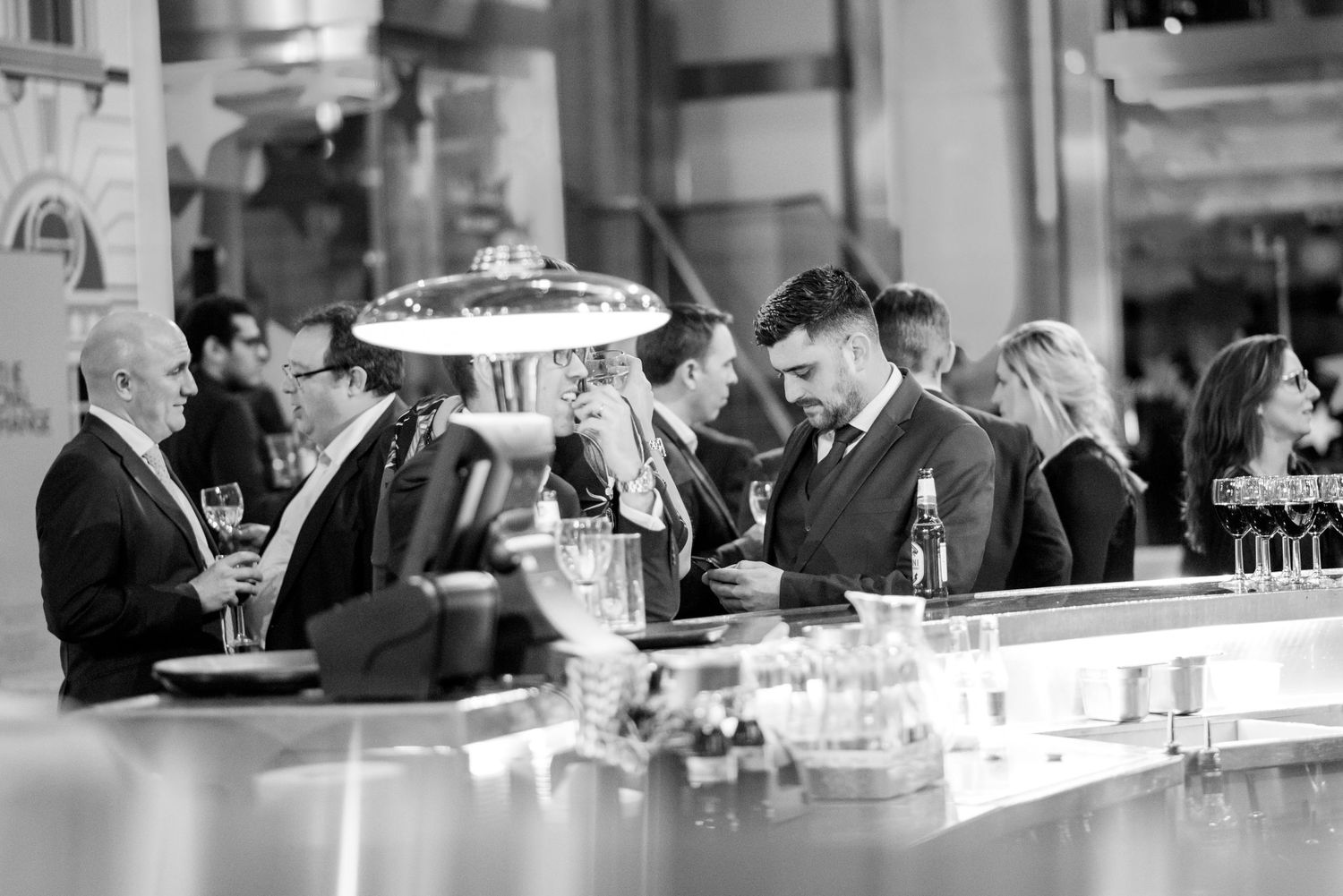 People gathered at an upscale bar area during an evening event.