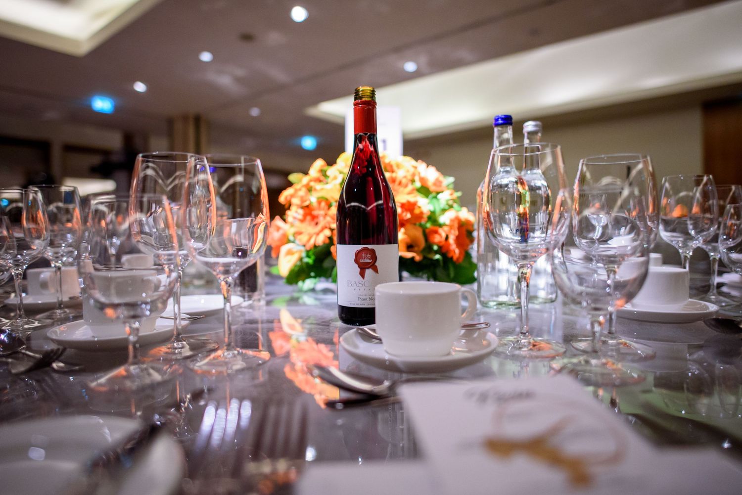 Elegant table settings with wine glasses and place settings in a formal dining room.