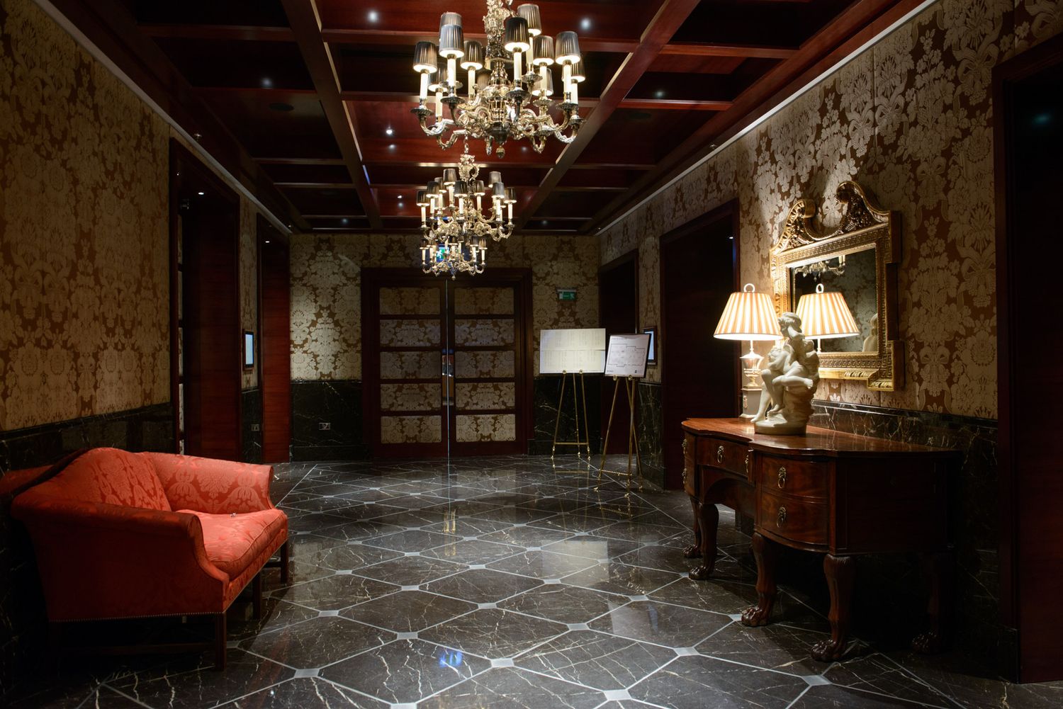 Elegant vintage room interior with crystal chandeliers and marble flooring.