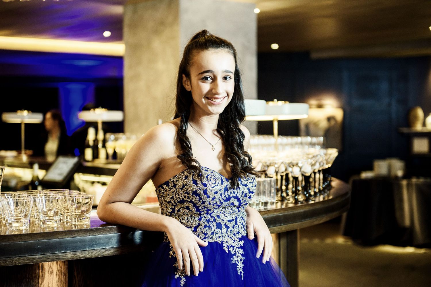Elegant blue and white decor at an evening reception with champagne glasses and mood lighting.