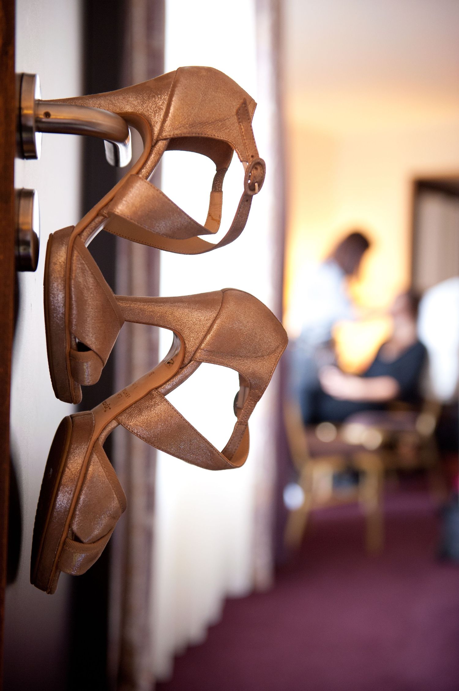Abstract wooden sculpture with angular geometric shapes displayed in an art gallery setting.