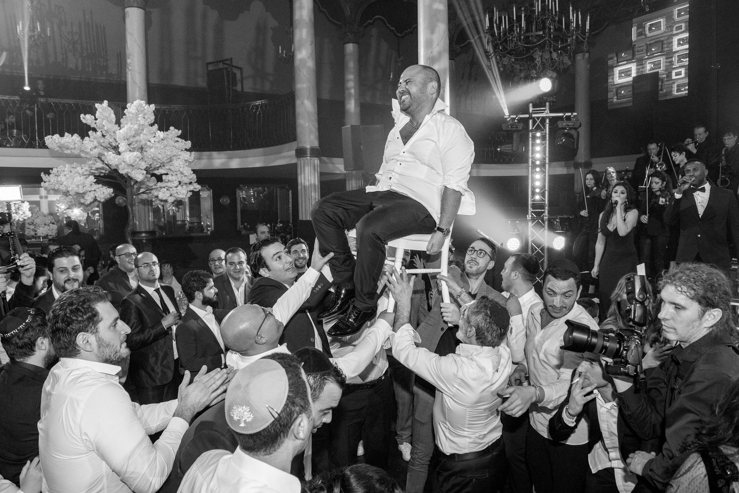 Black and white photographs showing people dancing and celebrating at what appears to be a nightclub or party setting.