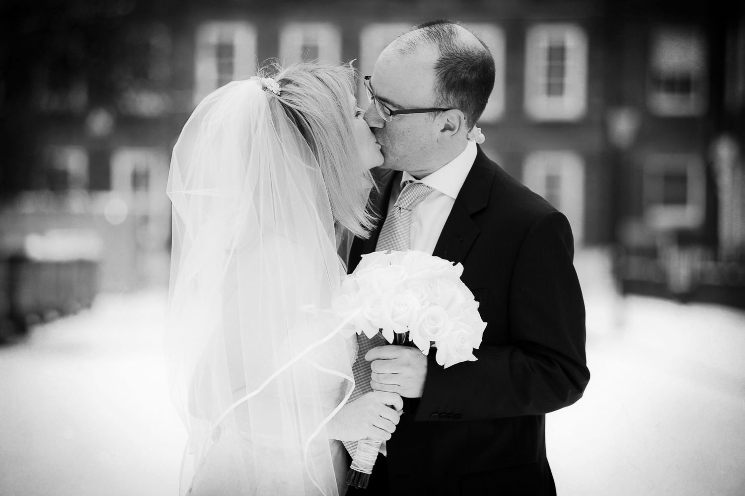 Black and white wedding portraits showing intimate moments between newlyweds.