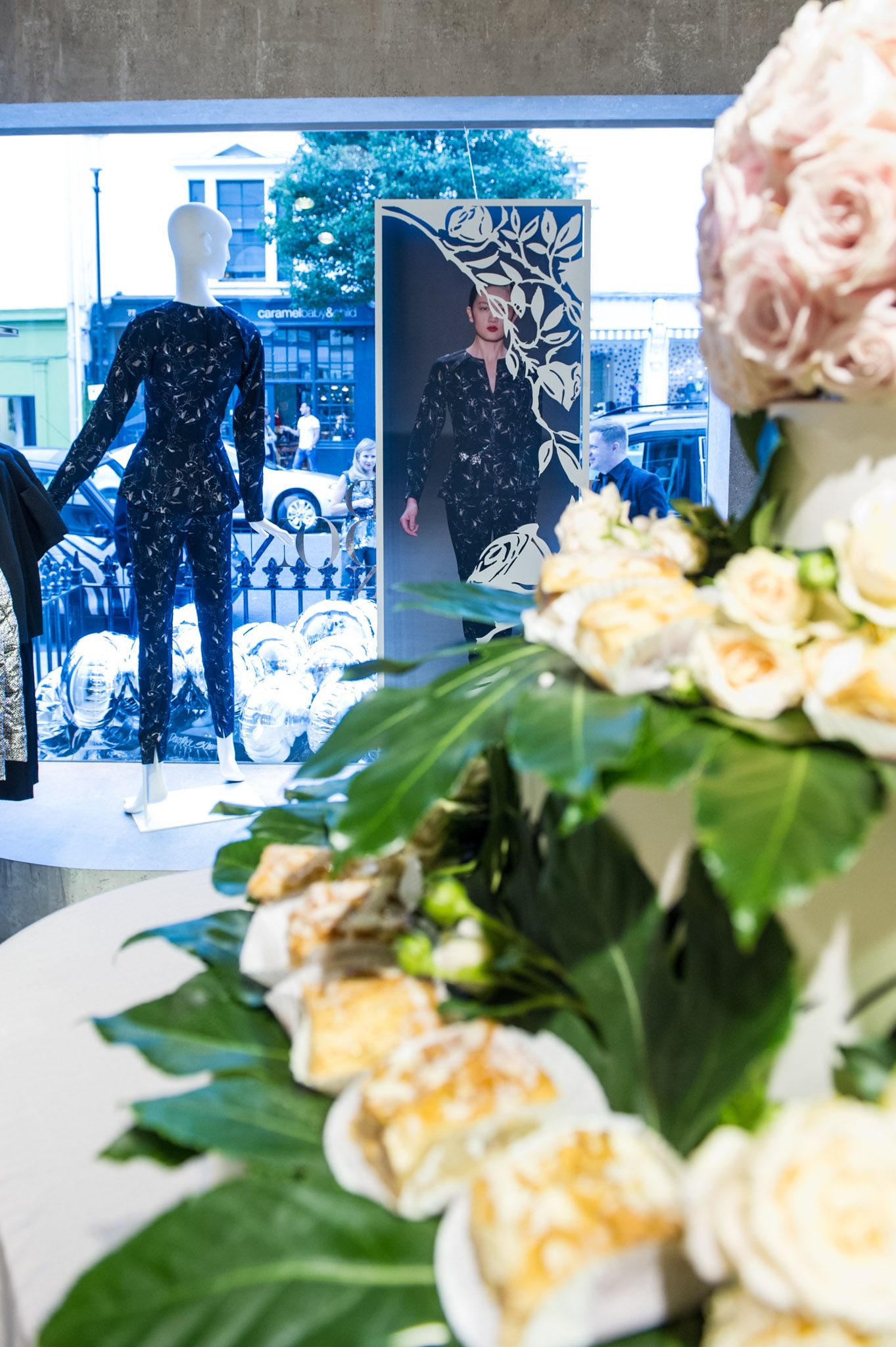 Fresh floral arrangements with white blooms and green foliage on display tables.