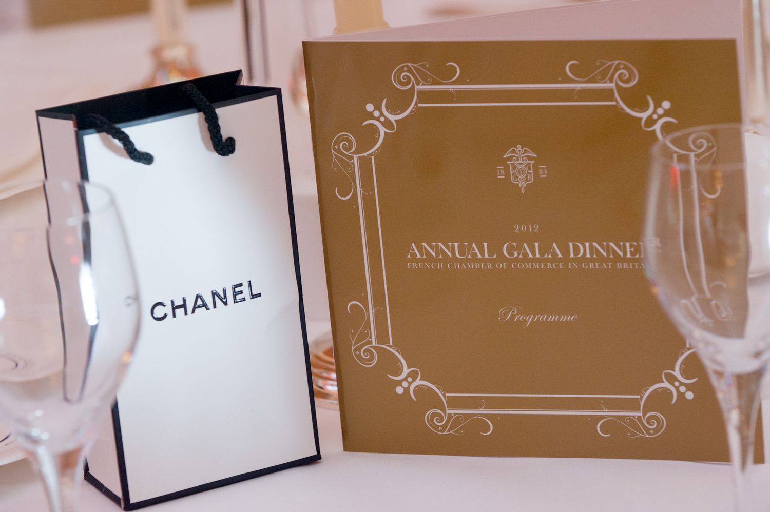 Luxury event branding with Chanel logo and gold accents for an annual gala dinner.