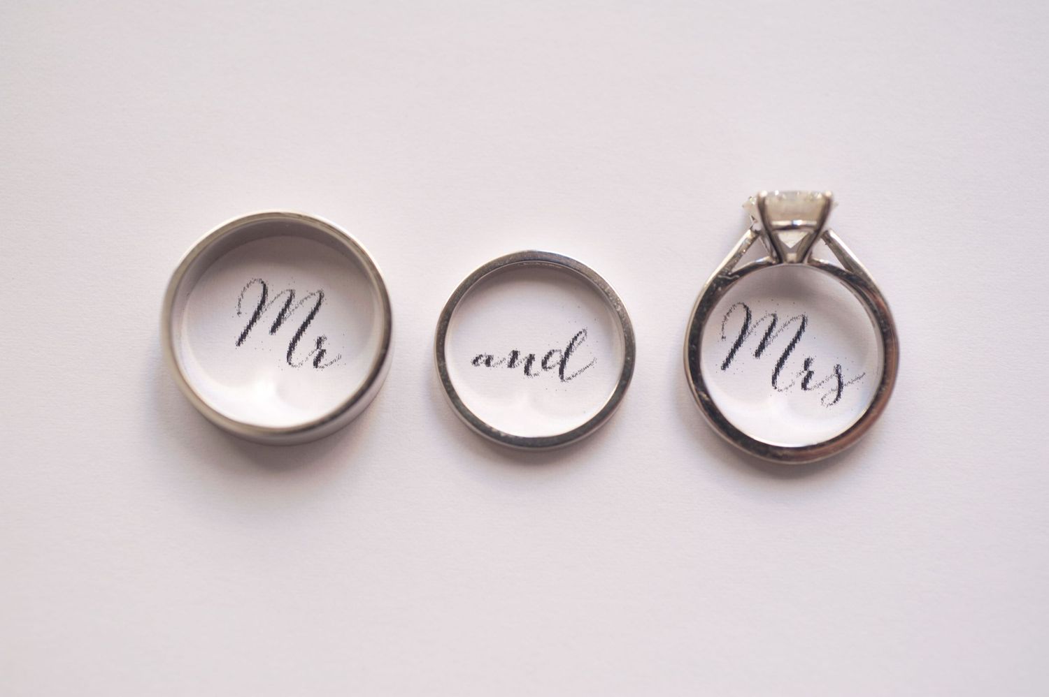 White ceramic ring dishes with elegant calligraphy text displayed in a minimalist style on a light background.
