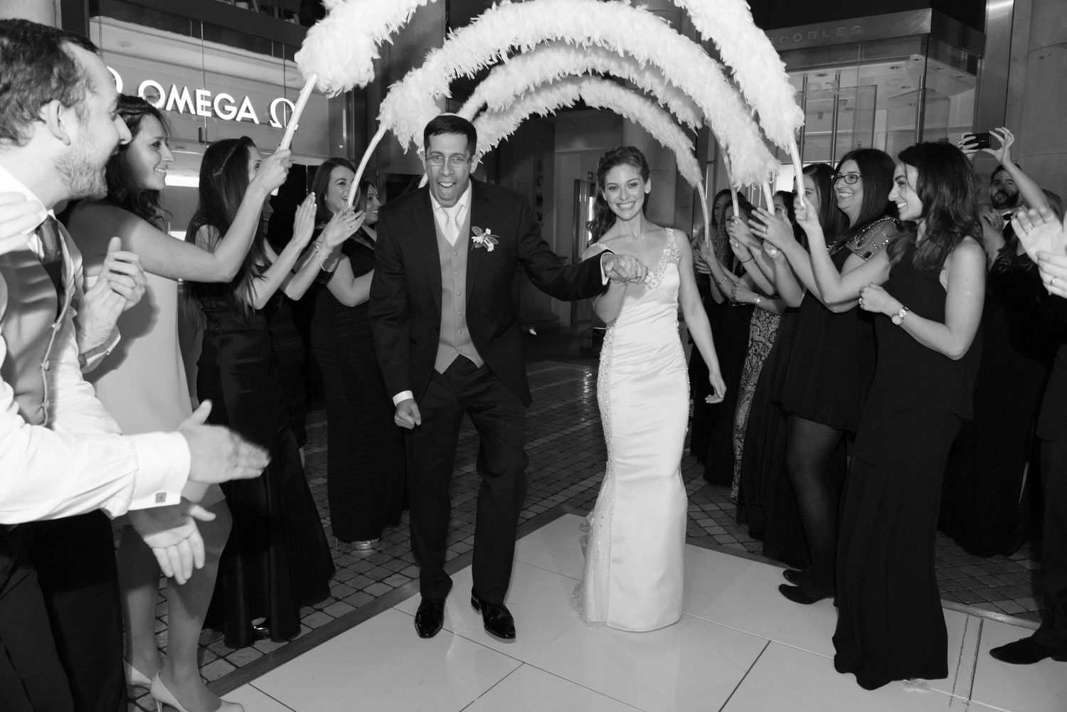 Wedding guests dance and celebrate together on the dance floor at a black and white themed reception.