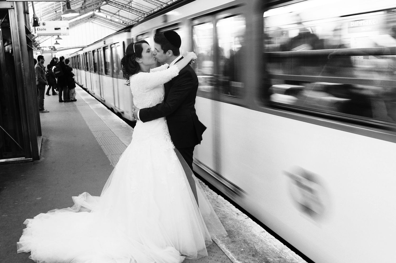 Series of romantic wedding photos taken at a train station platform.