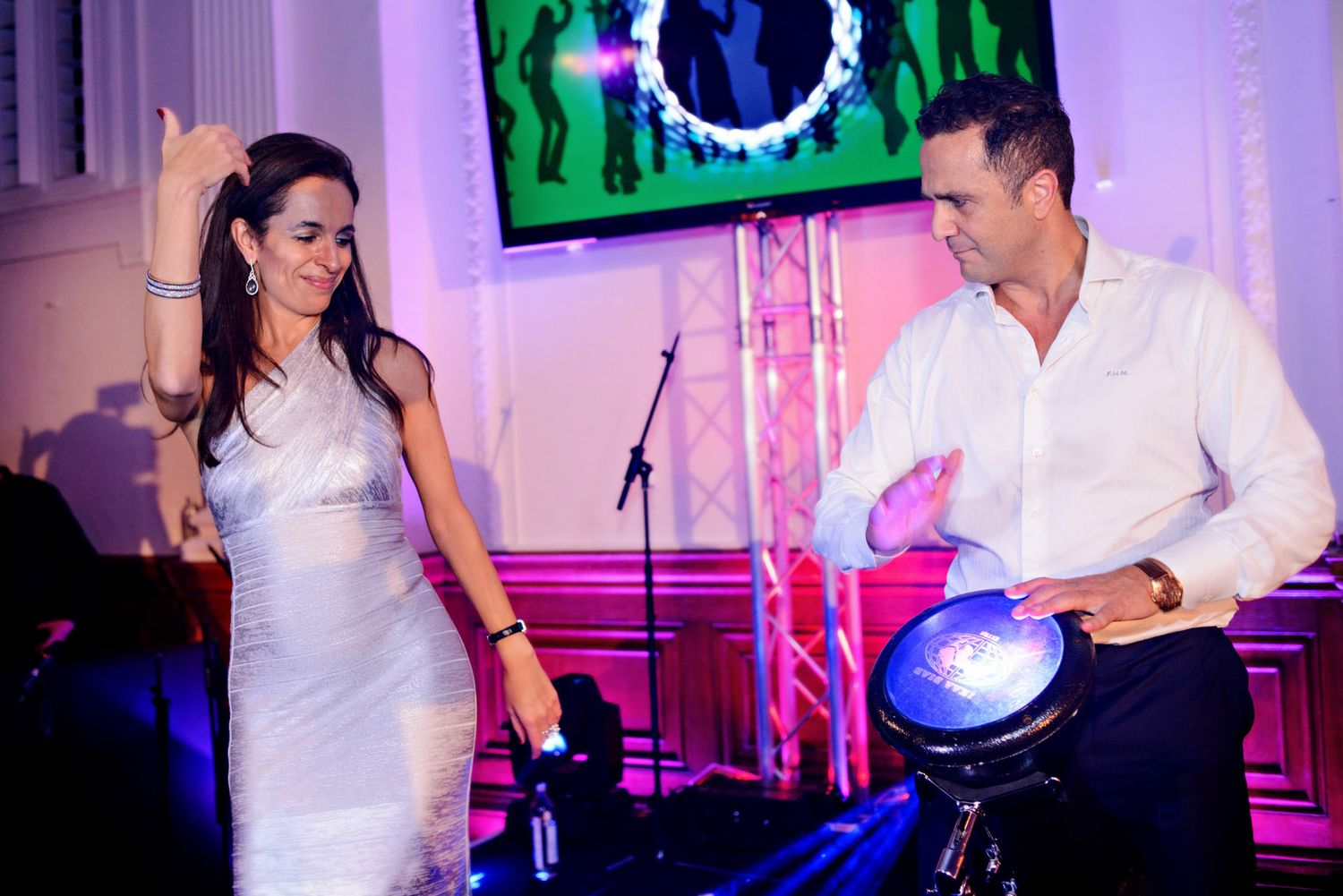 Wedding reception dance floor with purple and pink lighting creating a festive party atmosphere.