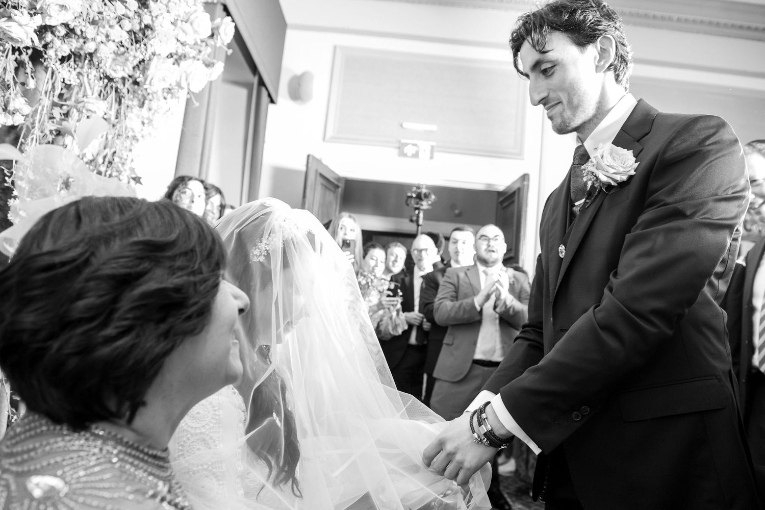 A series of black and white candid wedding reception photos showing dancing and celebration moments.