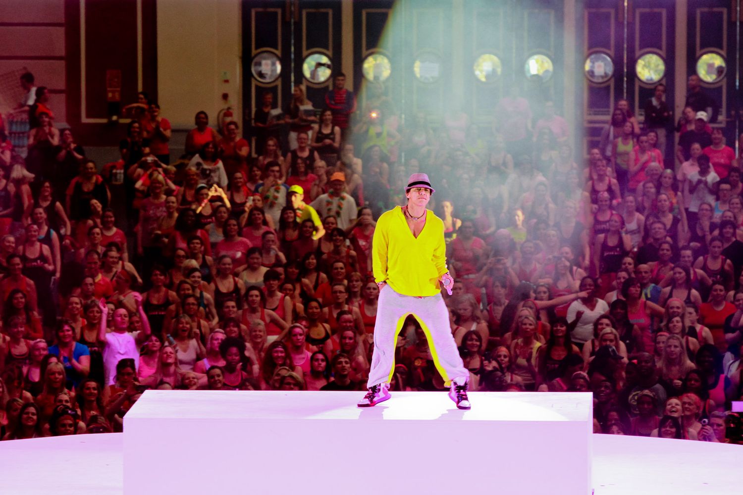 Concert performance on stage with colorful lighting and large audience.