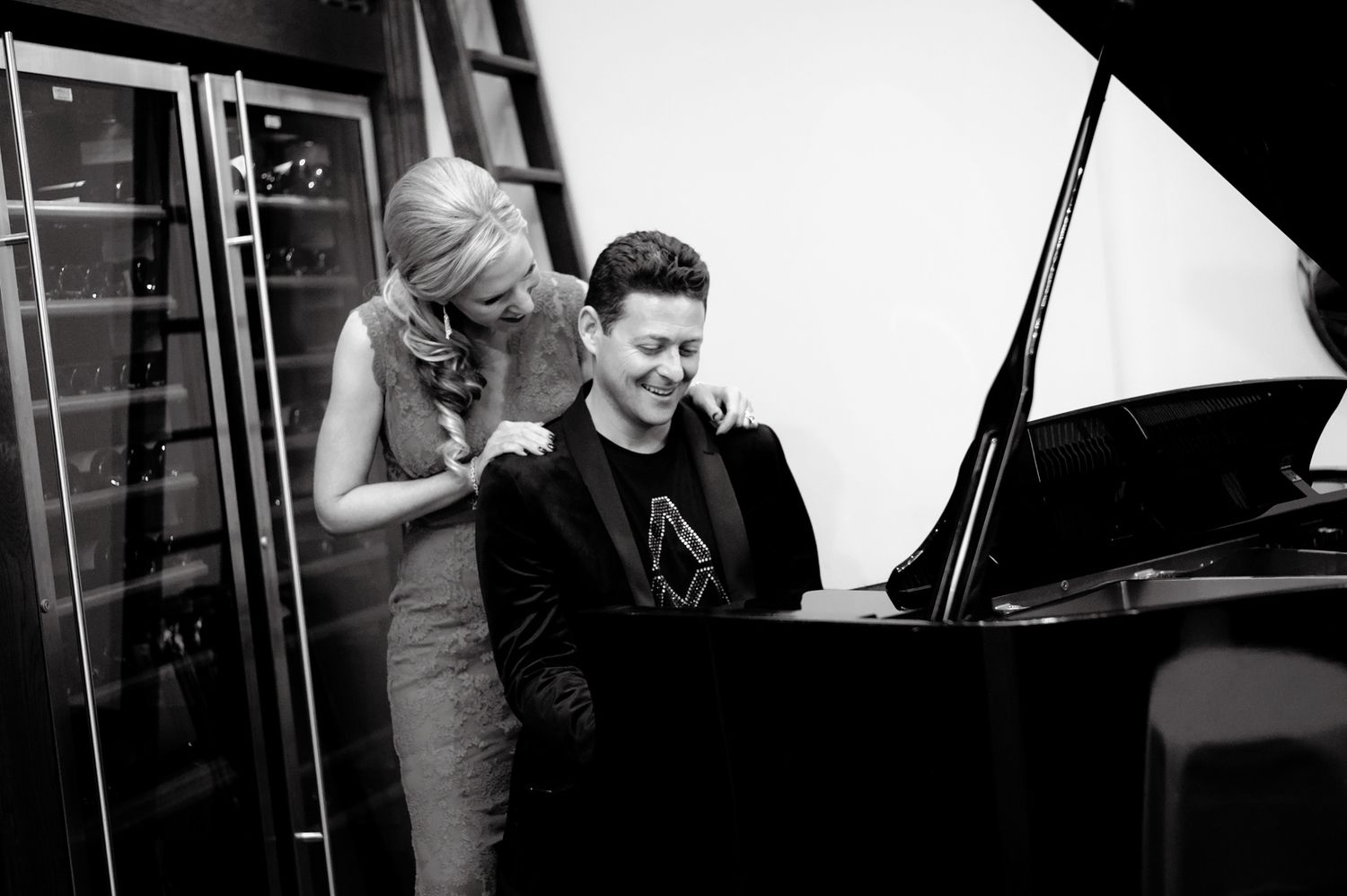 Musicians perform together on stage during a black and white concert performance.
