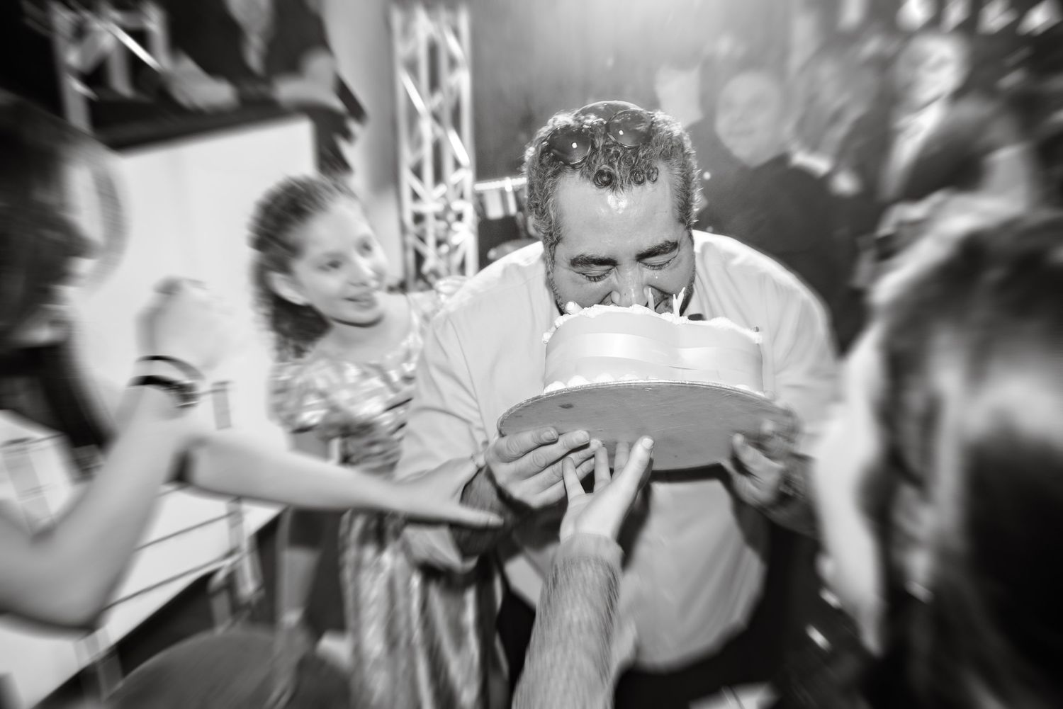A black and white montage of people dancing at what appears to be a crowded party or celebration.