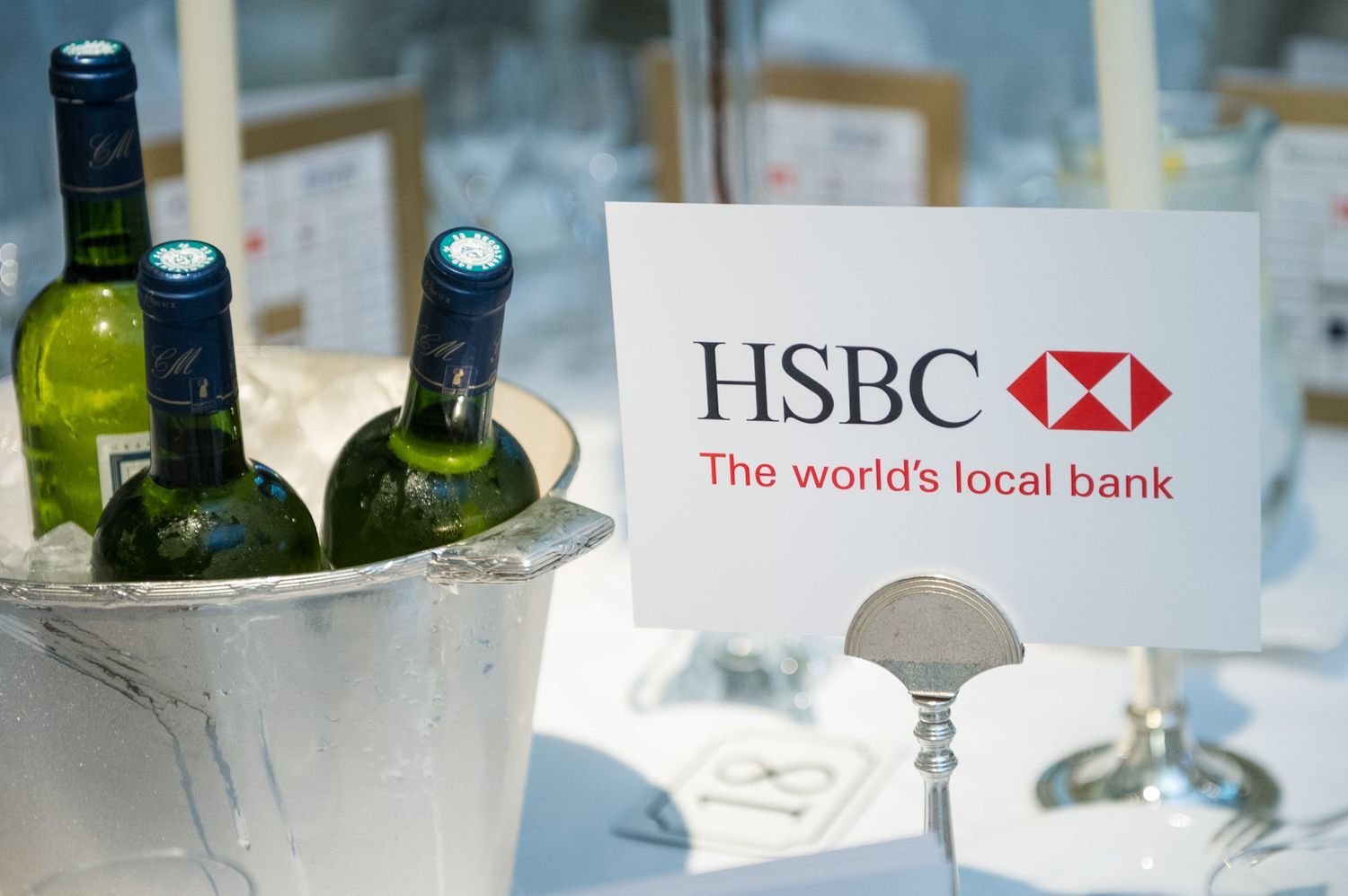 HSBC bank branding displayed with wine bottles and glassware at corporate event.
