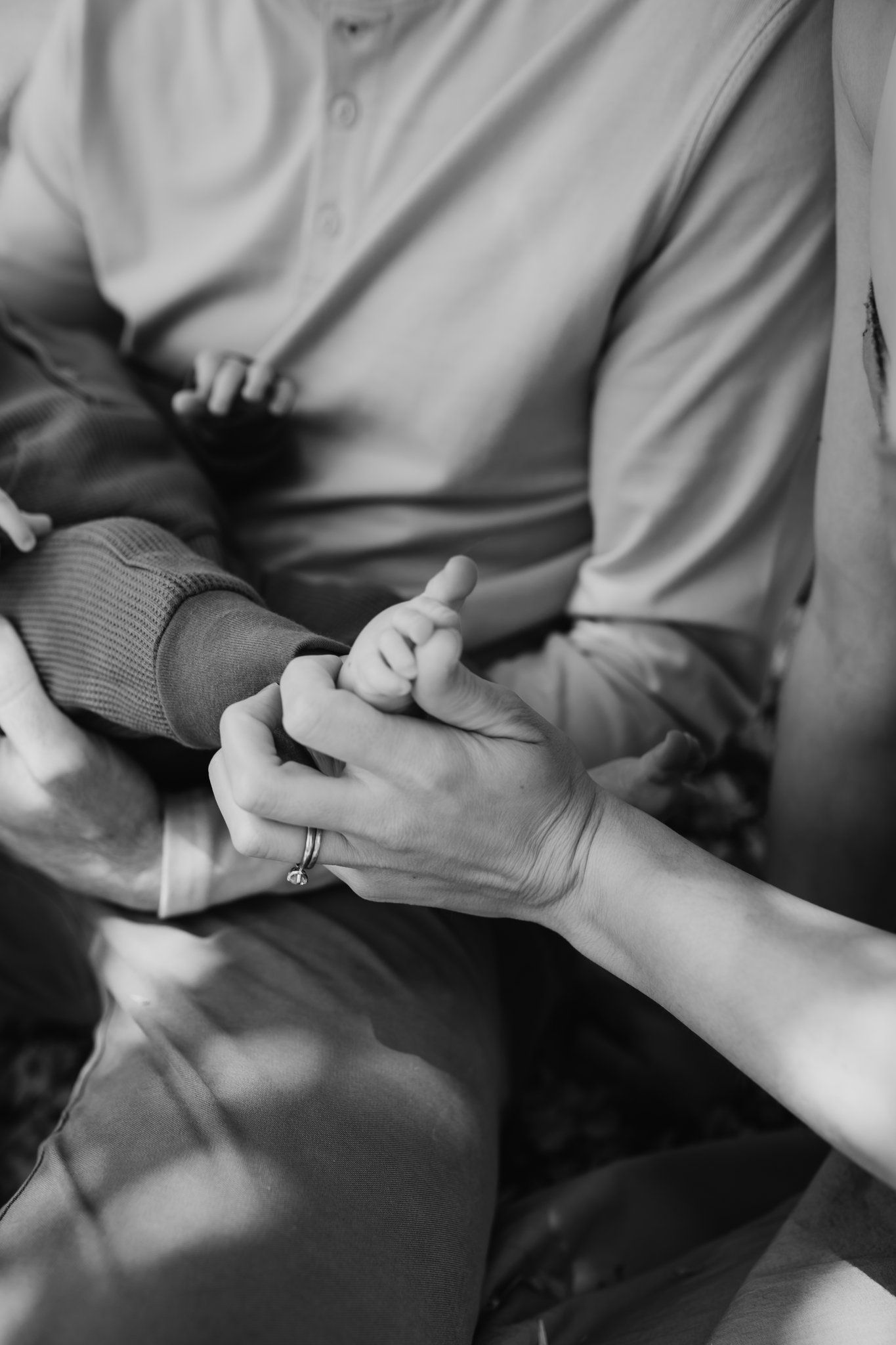 Detail shot of mom's hand on baby's foot