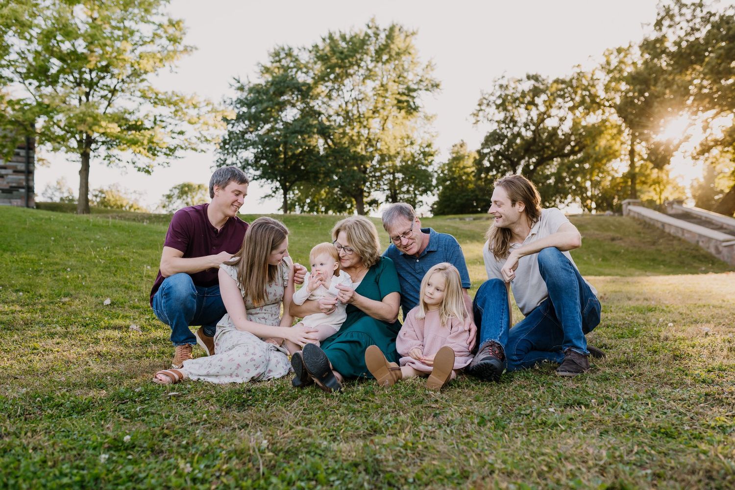 Extended family poses together and plays with the children during photoshoot
