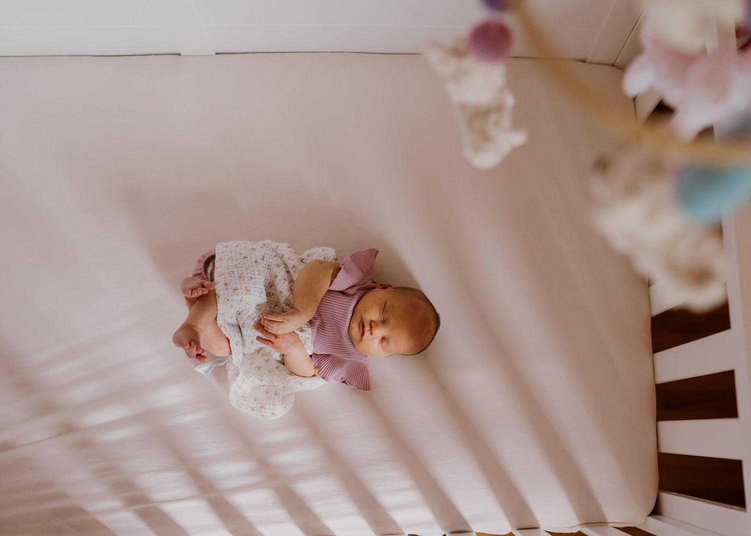 Baby girl sleeps in her crib Knoxville home birth resources