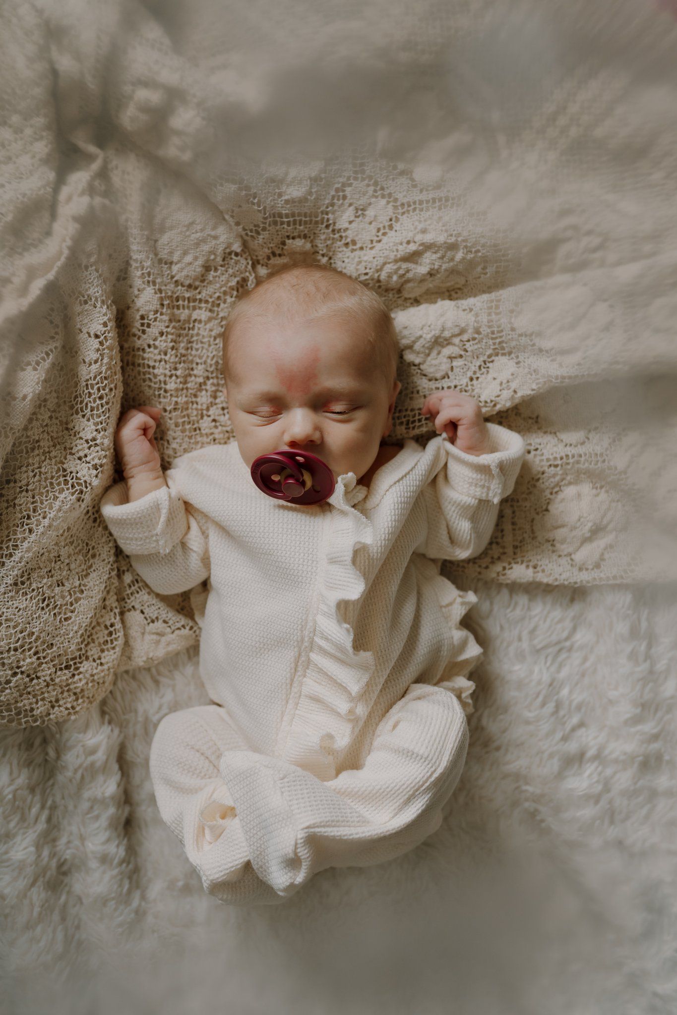 Newborn baby with pacifier sleeping