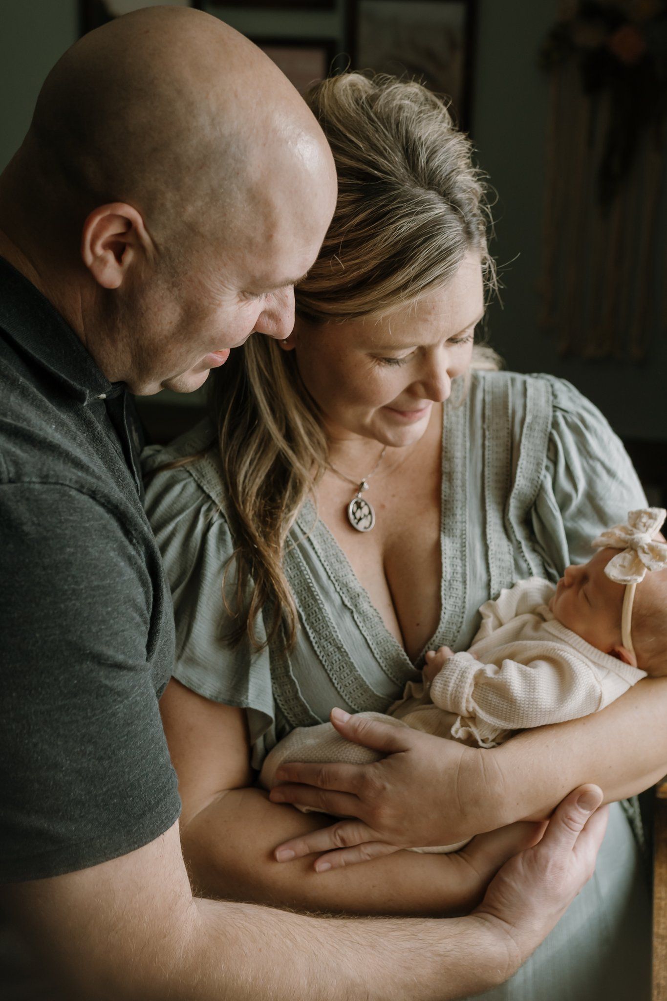 couple gazing lovingly at their newborn during their lifestyle newborn session knoxville newborn photographer