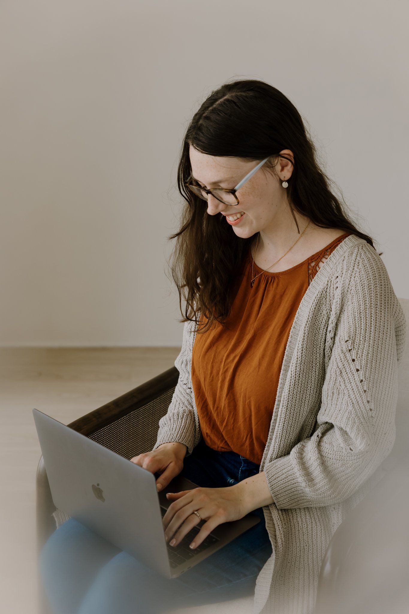 Woman looks at computer and smiles