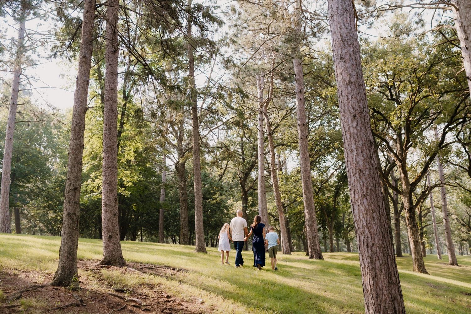 Family with young children plays together at golden hour