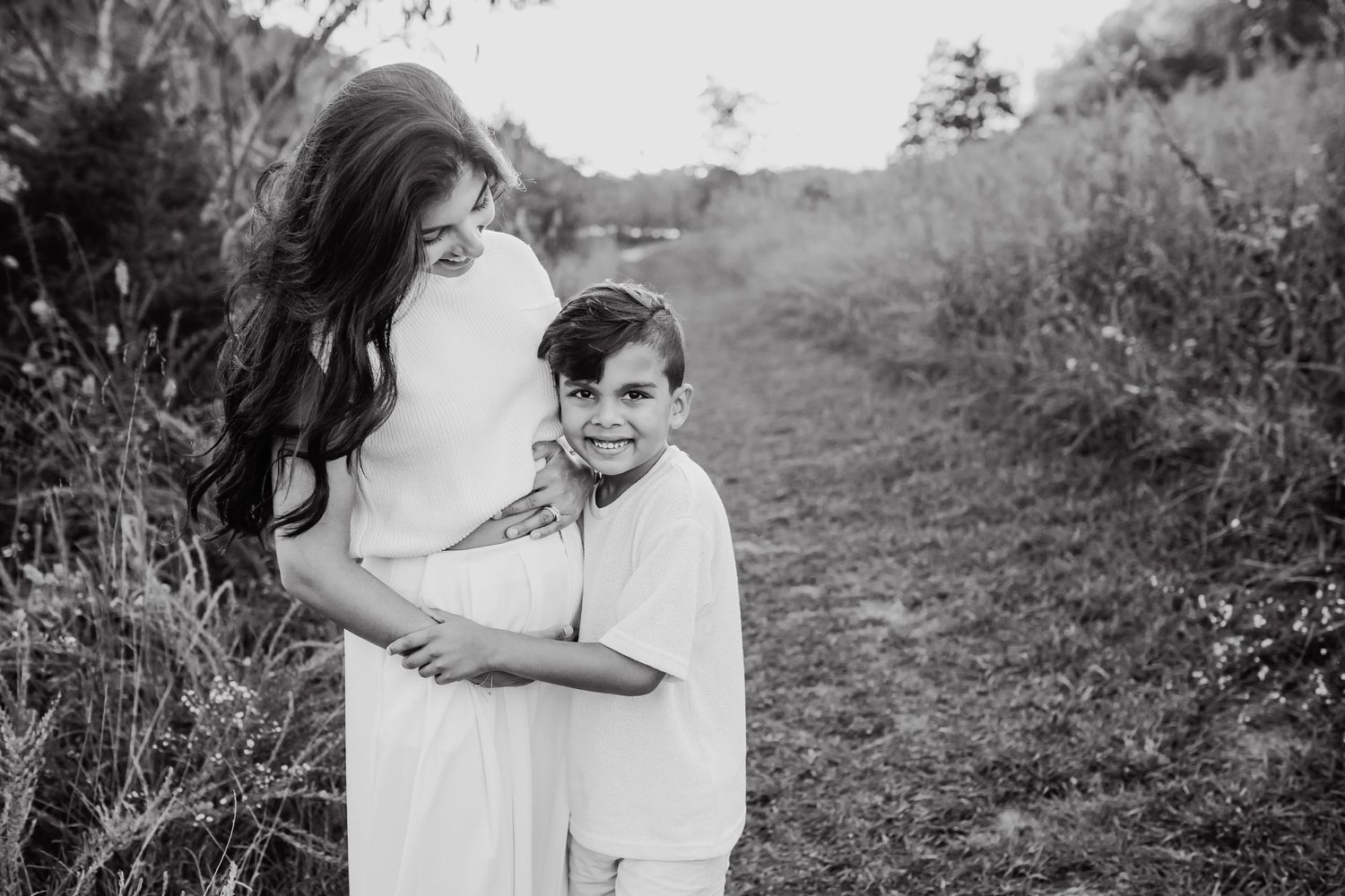 Pregnant mom is hugged by her son during family maternity photos in knoxville