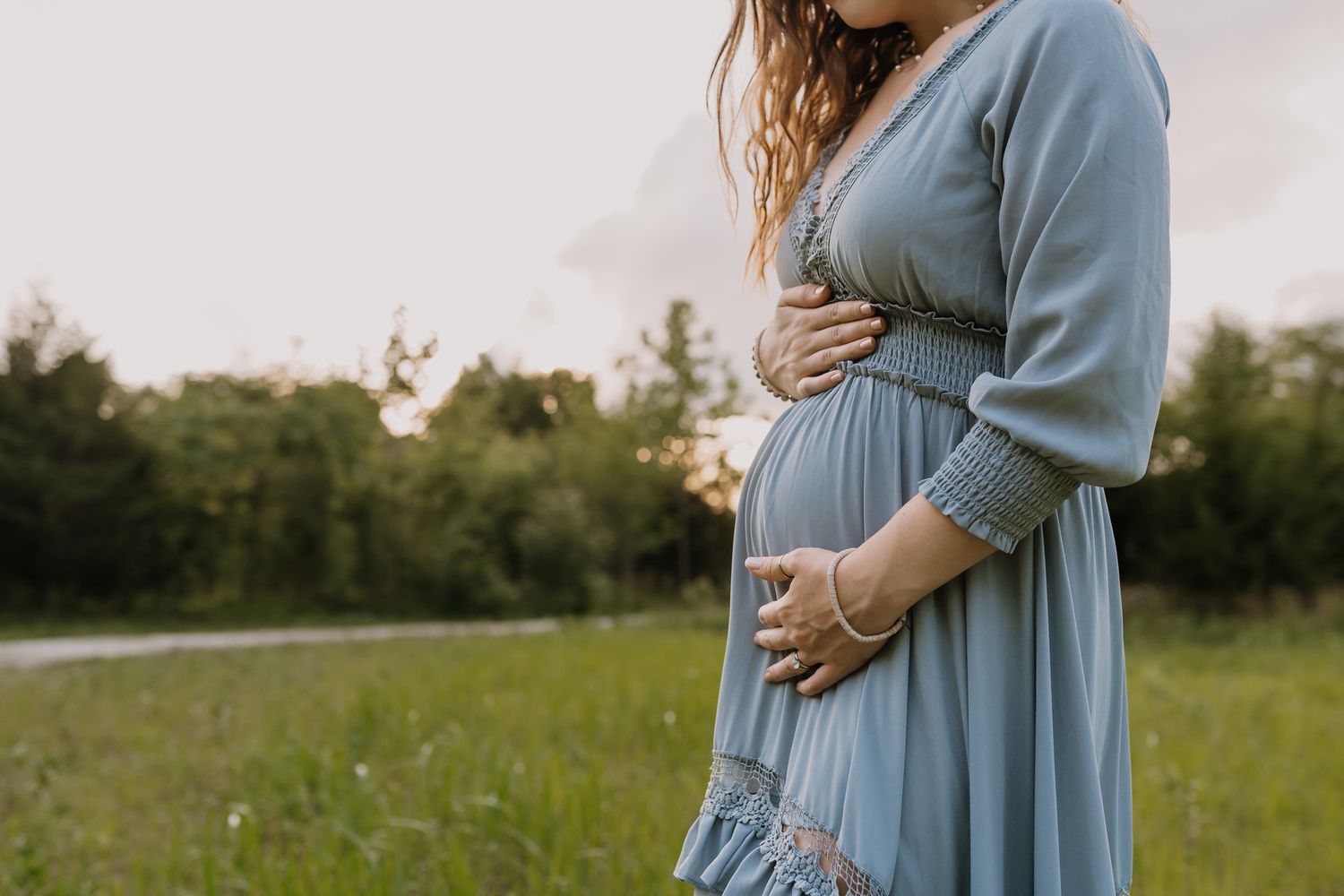 Pregnant mom holds her belly during maternity photography session Maryville Tennessee