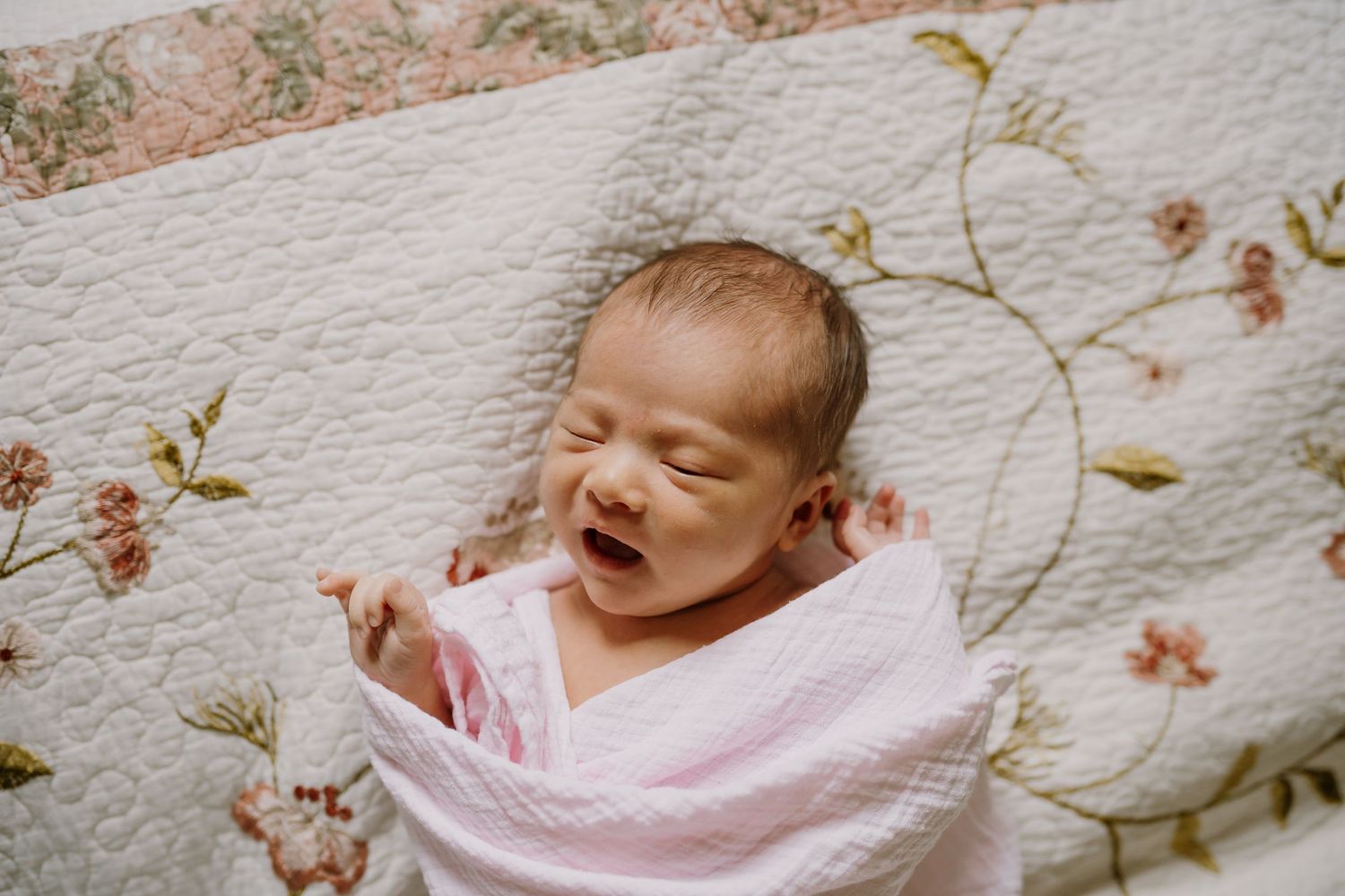 newborn baby yawns during in home lifestyle photos