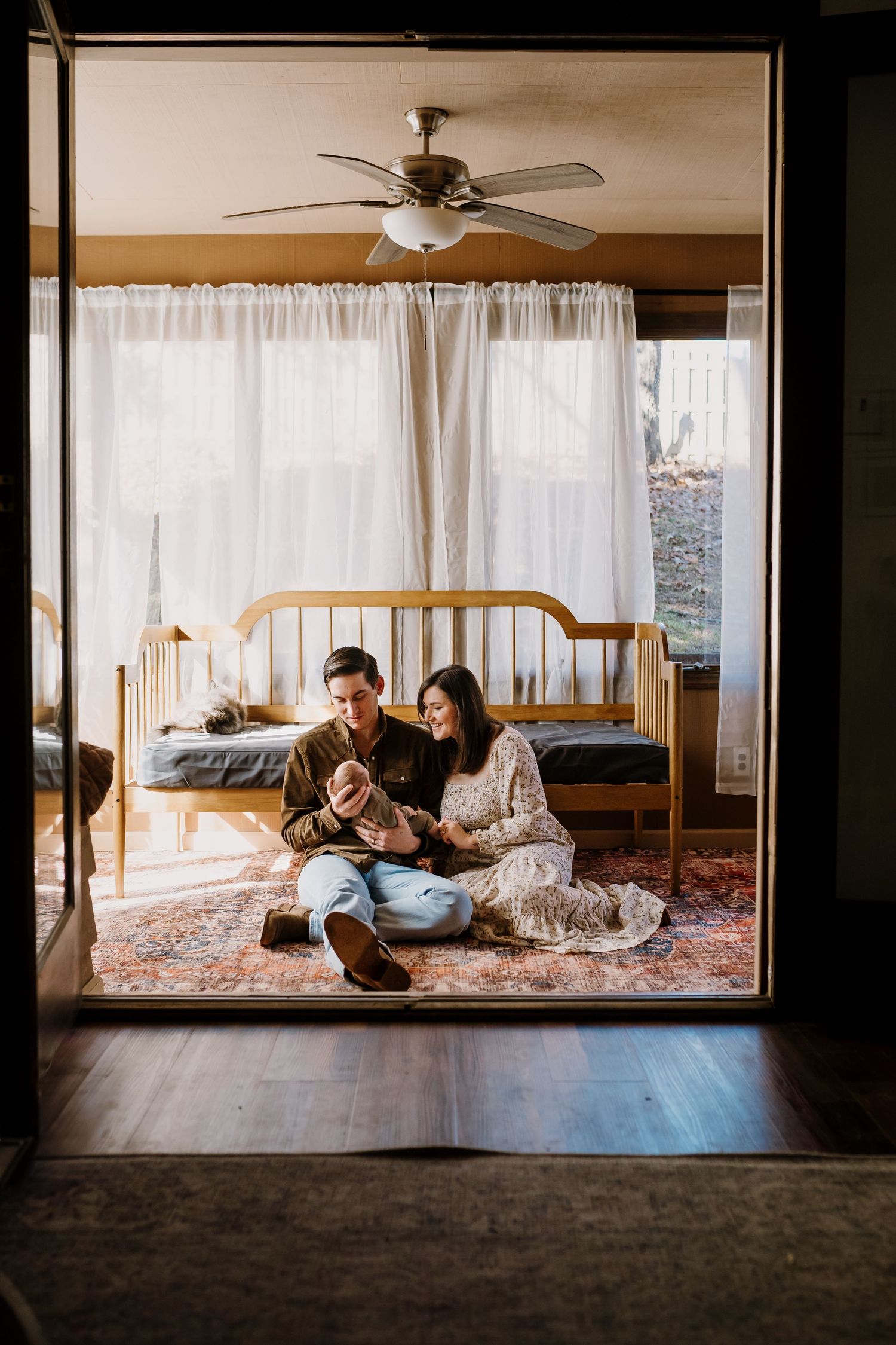 family in home newborn session with older newborn in their sunlit home with maryville newborn photographer