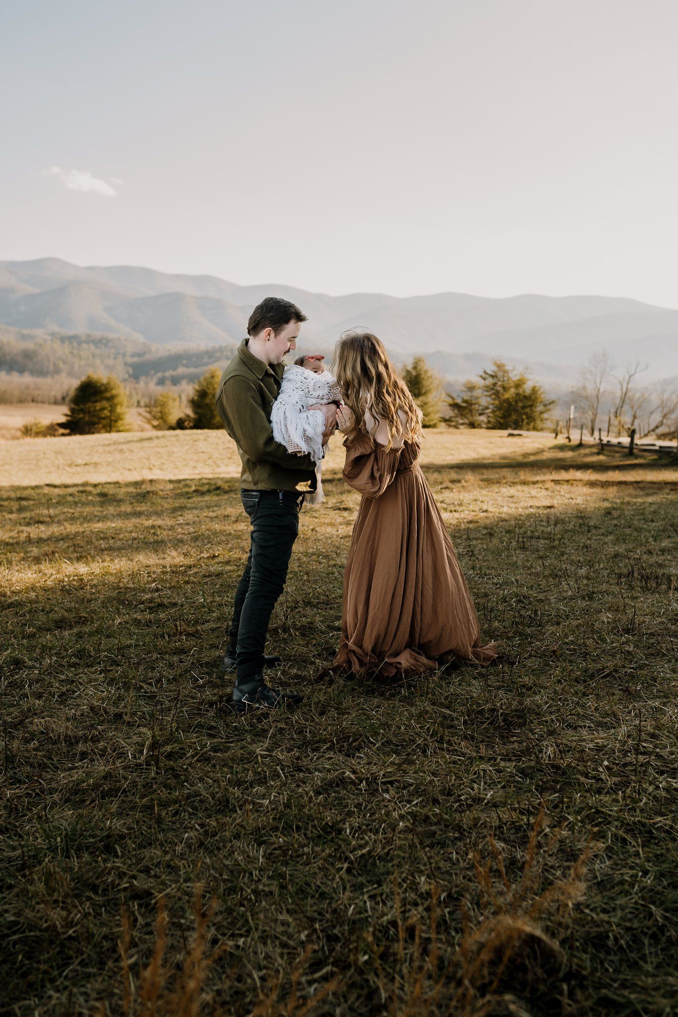 family in cades cove poses for pictures