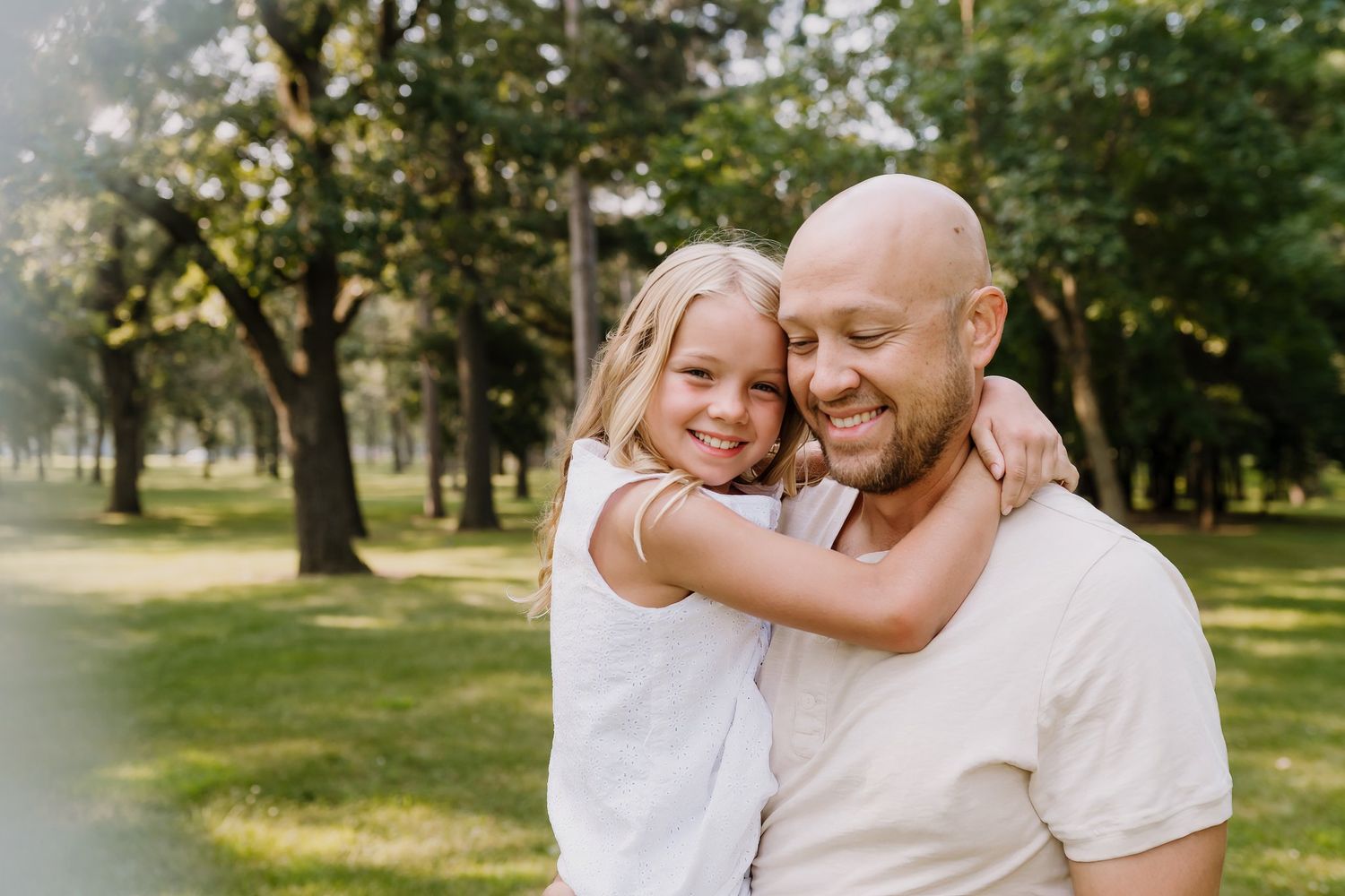 Dad snuggles his daughter