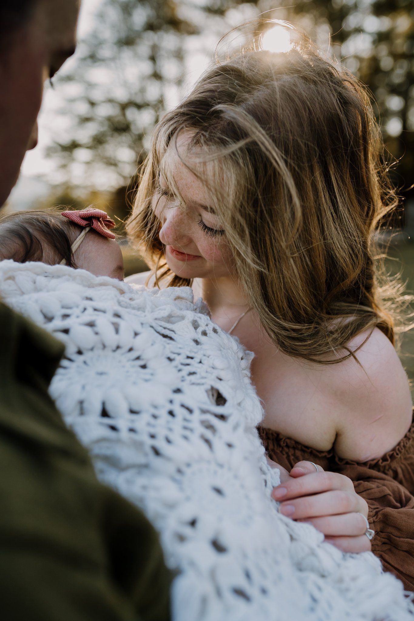 mom smiles at baby girl during family photos in cades cove