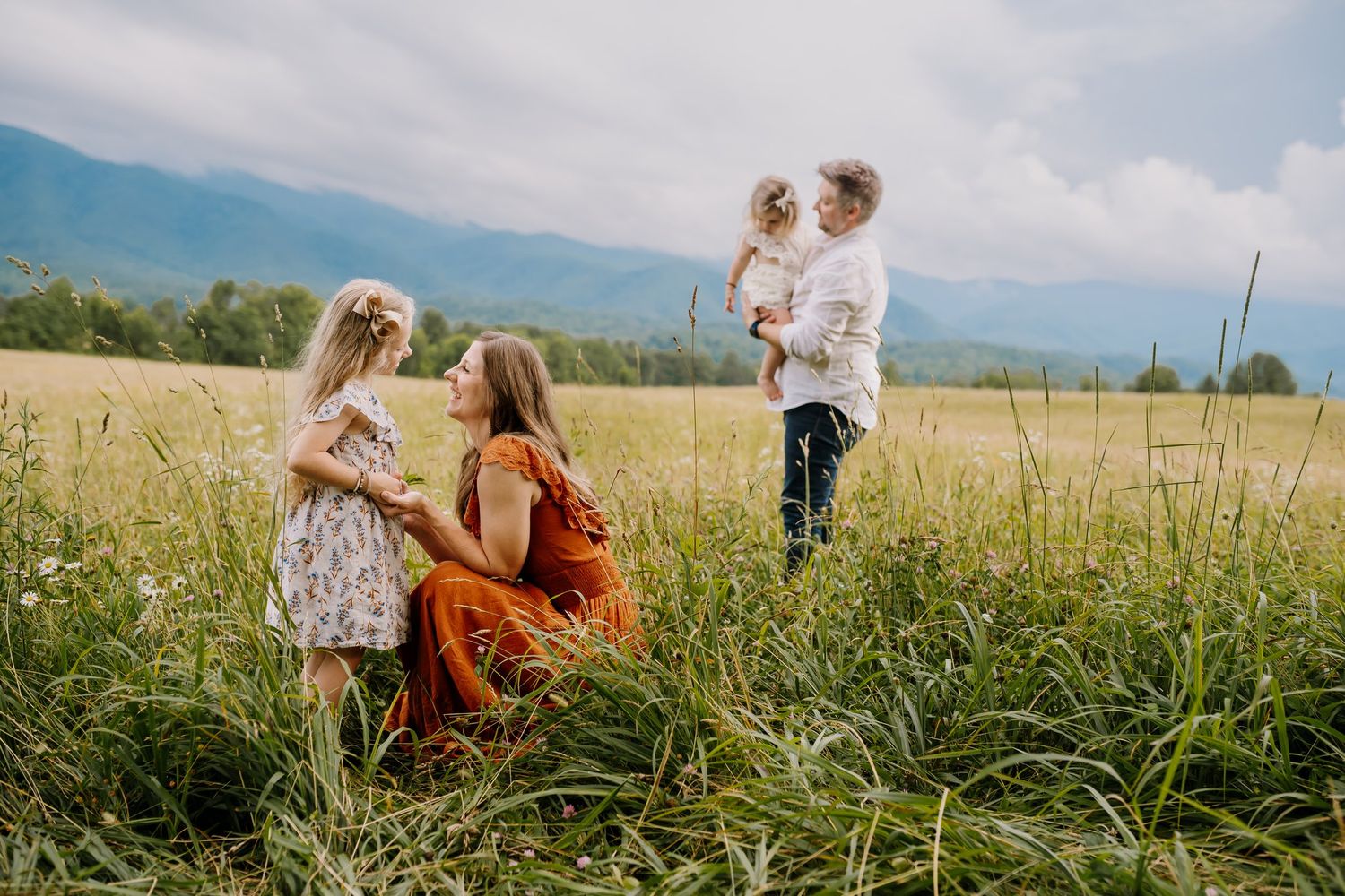 Family with young children play during cades cove photography session