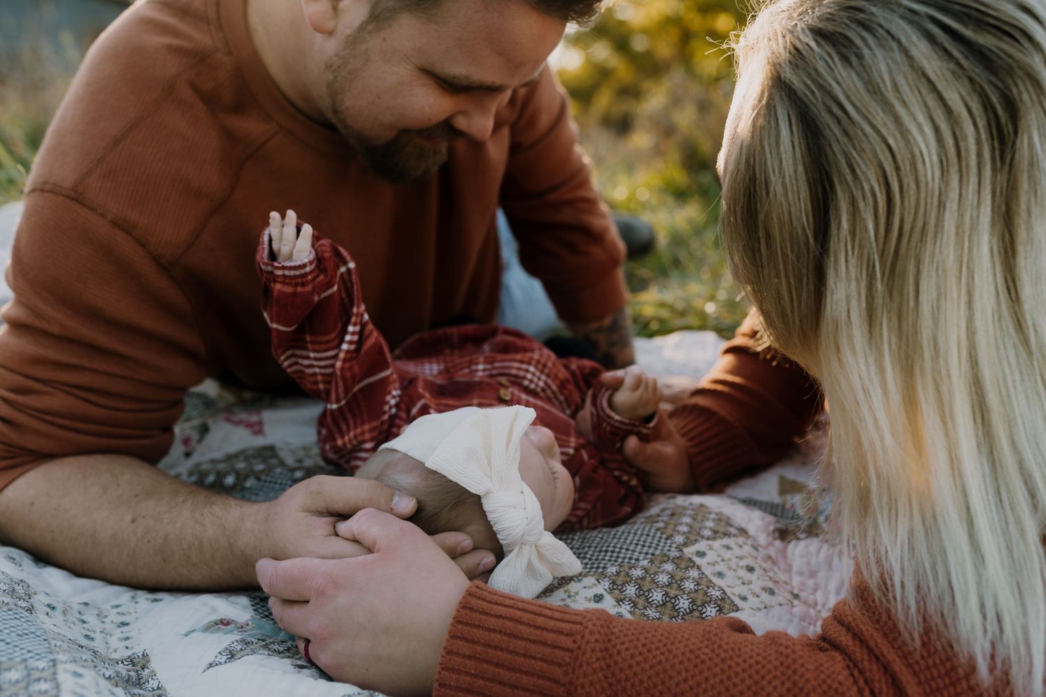 mom and dad looking at baby